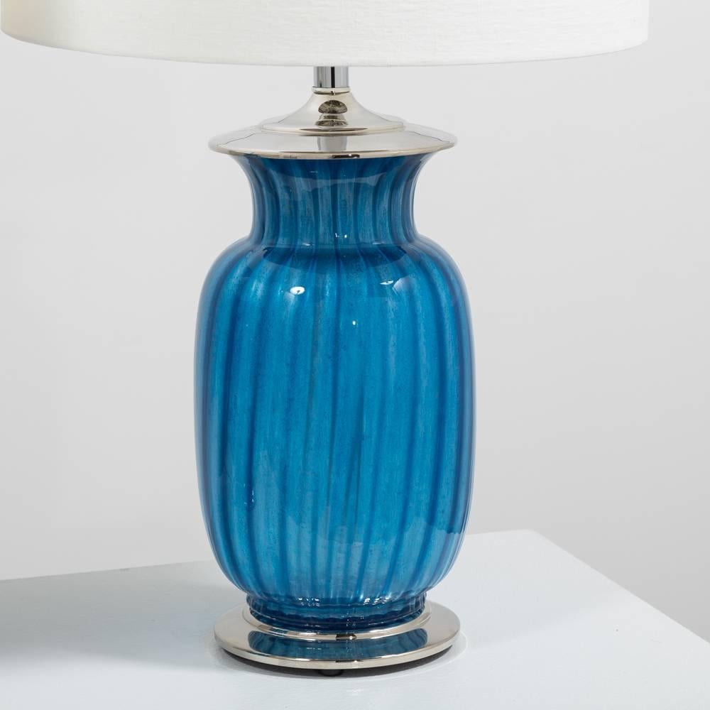 A Pair of Blue Glass Table Lamps on Nickel Plated Bases 1960s 
Fully reconditioned by our team  
Custom made new shades have been made for this pair of lamps as well as full wiring restoration to meet UK standards.
NB: Price includes 20% VAT which