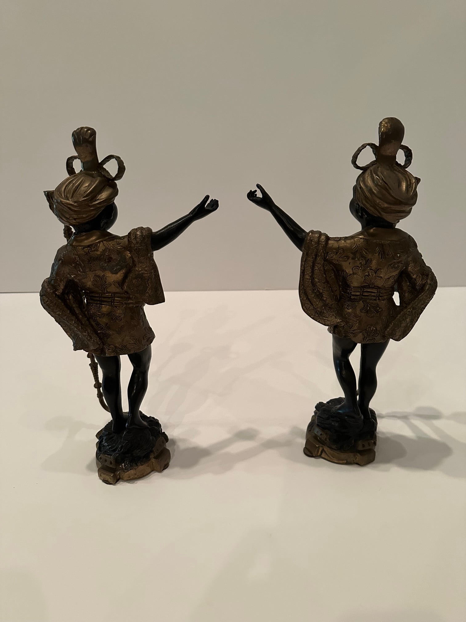 Stylish pair of bronze ebonized Venetian candlesticks in the form of blackamoors having incredible detailing.