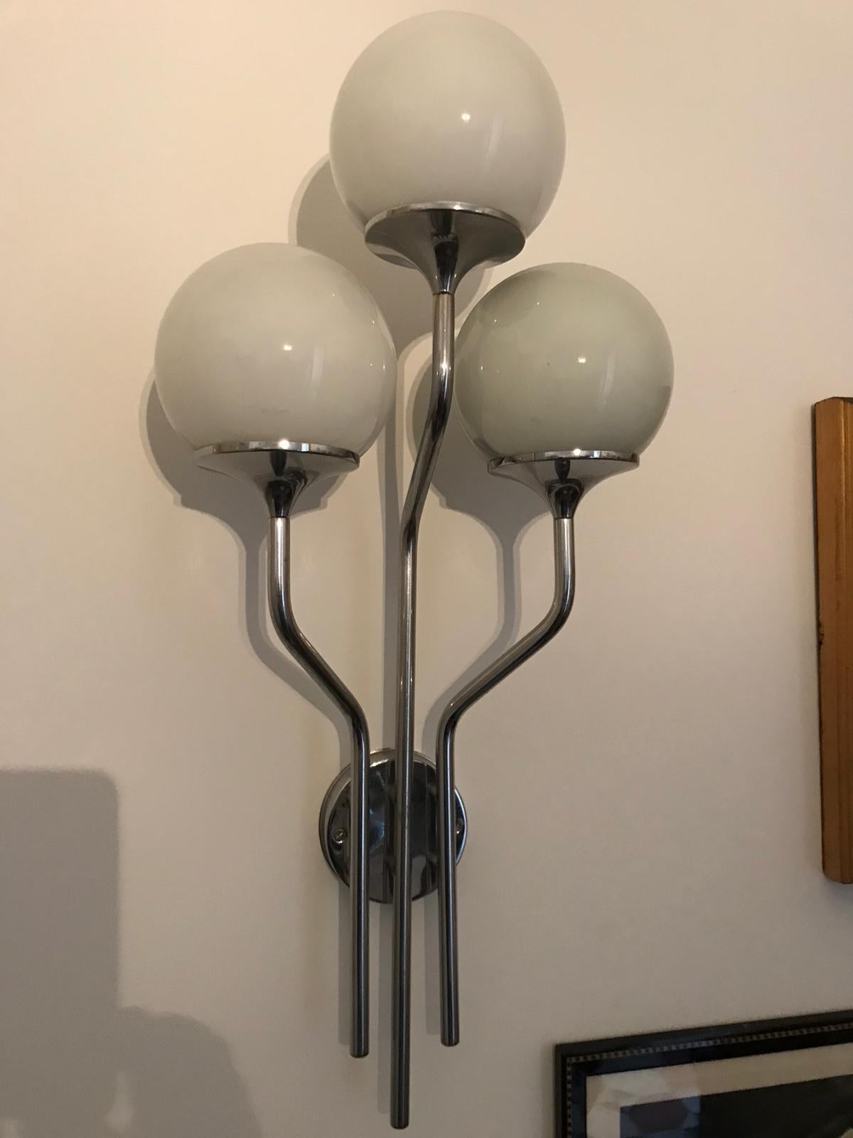 Pair of Italian wall lights in chrome with opaline glass shades by Goffredo Reggiani produced by Studio Reggiani. Made in Italy from the 1960s.