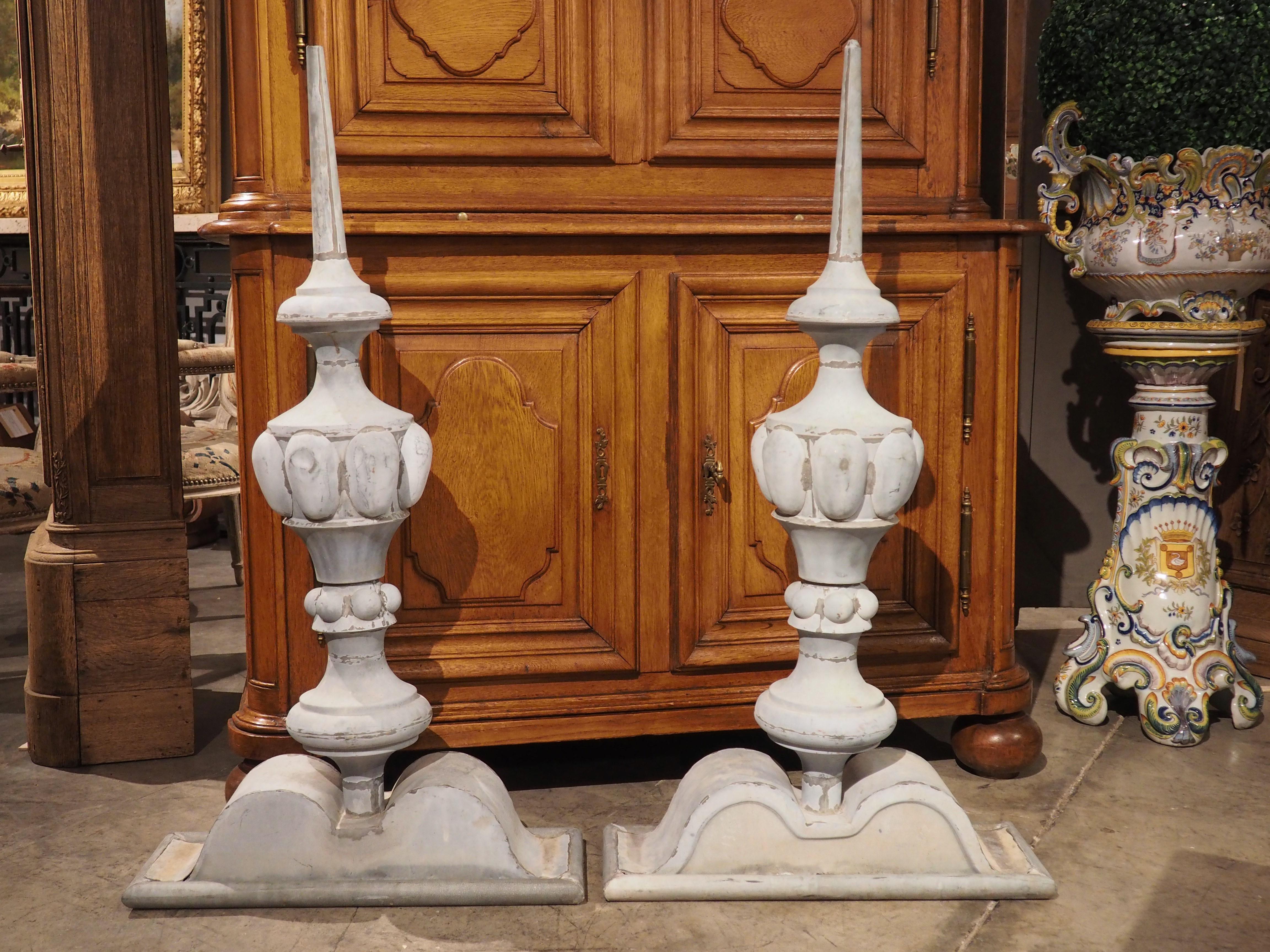 This stunning pair of zinc roof finials were fashioned for a rooftop in France, circa 1890. Both finials have a light gray hue, but a dark gray patination has developed in some areas from age and exposure to the elements. A rectangular base that