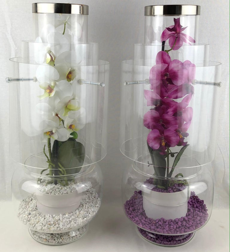 A vintage pair of Mid-Century Modern clear lead crystal and plexiglass orchid vases decorated with polished chrome. These stunning vases were created purely out of love. Giacomo an Italian designer from the southern region of France designed these