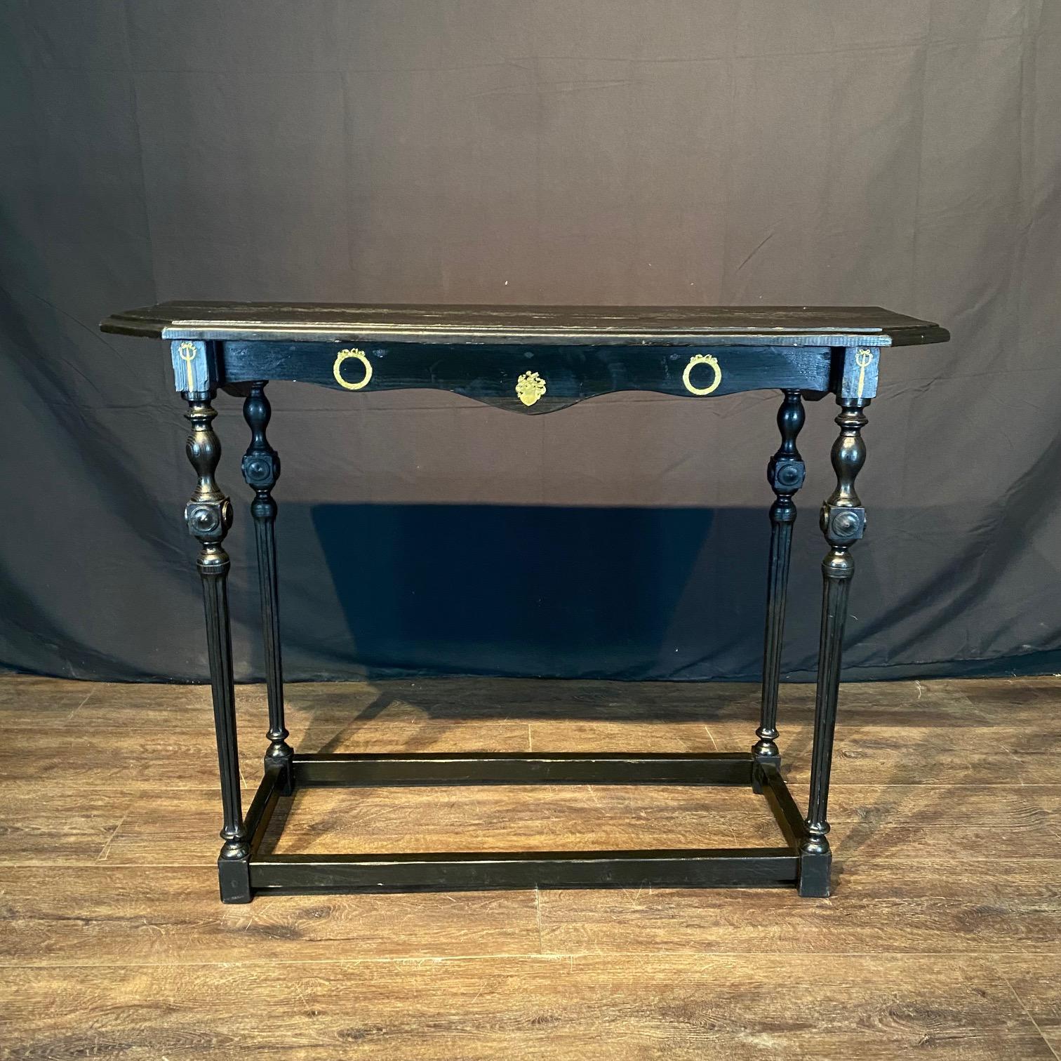 Elegant pair of Spanish ebonized black side tables, sofa tables, console tables  with hand turned and reeded legs and exquisite bronze embellishments. These classic accent tables feature a sturdy long rectangular top sitting above an exquisite base