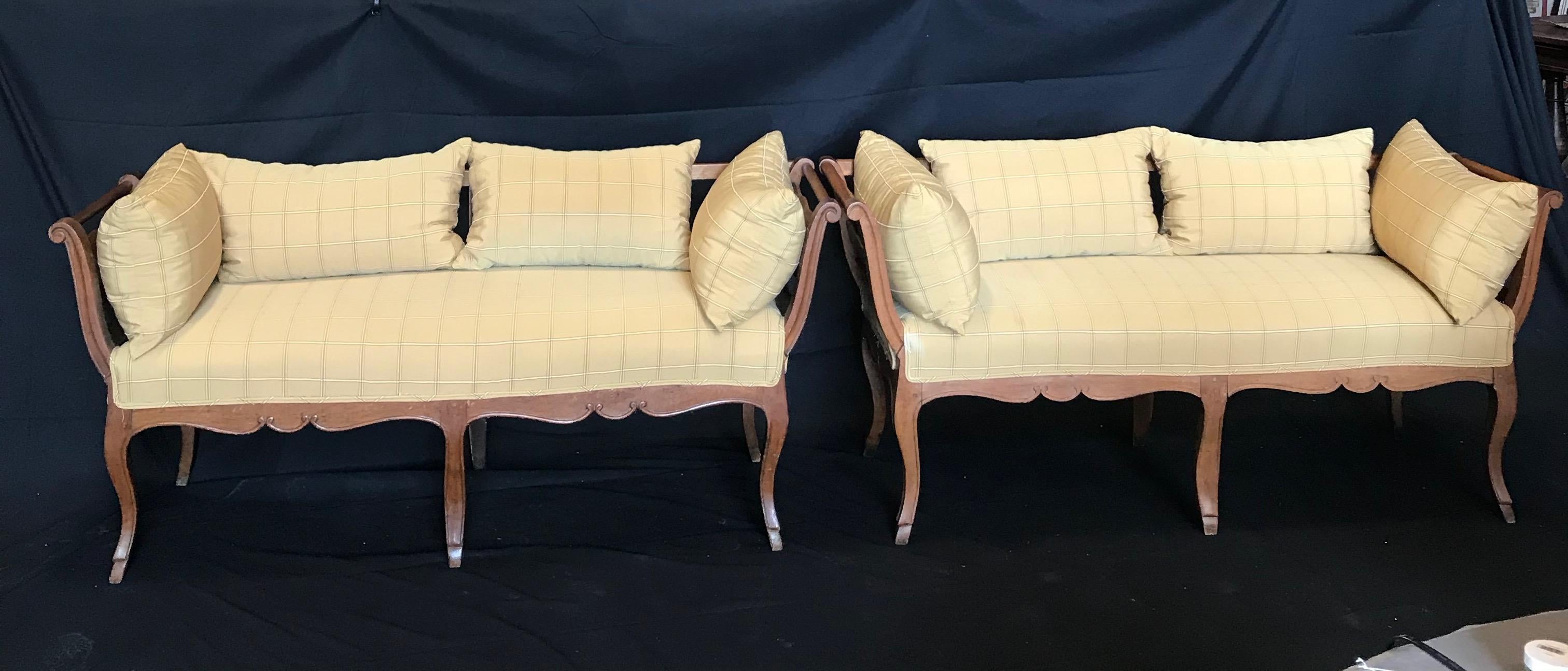 Stunning pair of 19th century French country Louis XV walnut settees having a provenance from the Westover Plantation in Virginia. The present family owned them for almost 100 years; originally from France. Upholstered in a silk neutral fabric.
 

