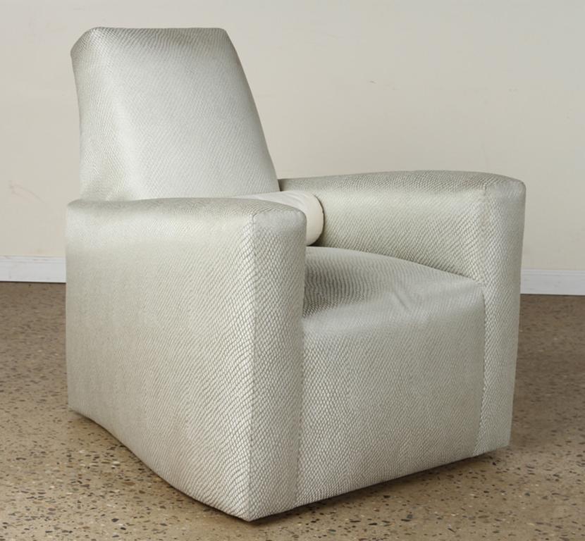 Stunning pair of Geoffrey Bradfield custom club chairs in a woven silver fabric. As chic as they are comfortable. A down lumbar pillow come with each chair. The chairs are on hidden swivel bases. 

Measures: 35.5