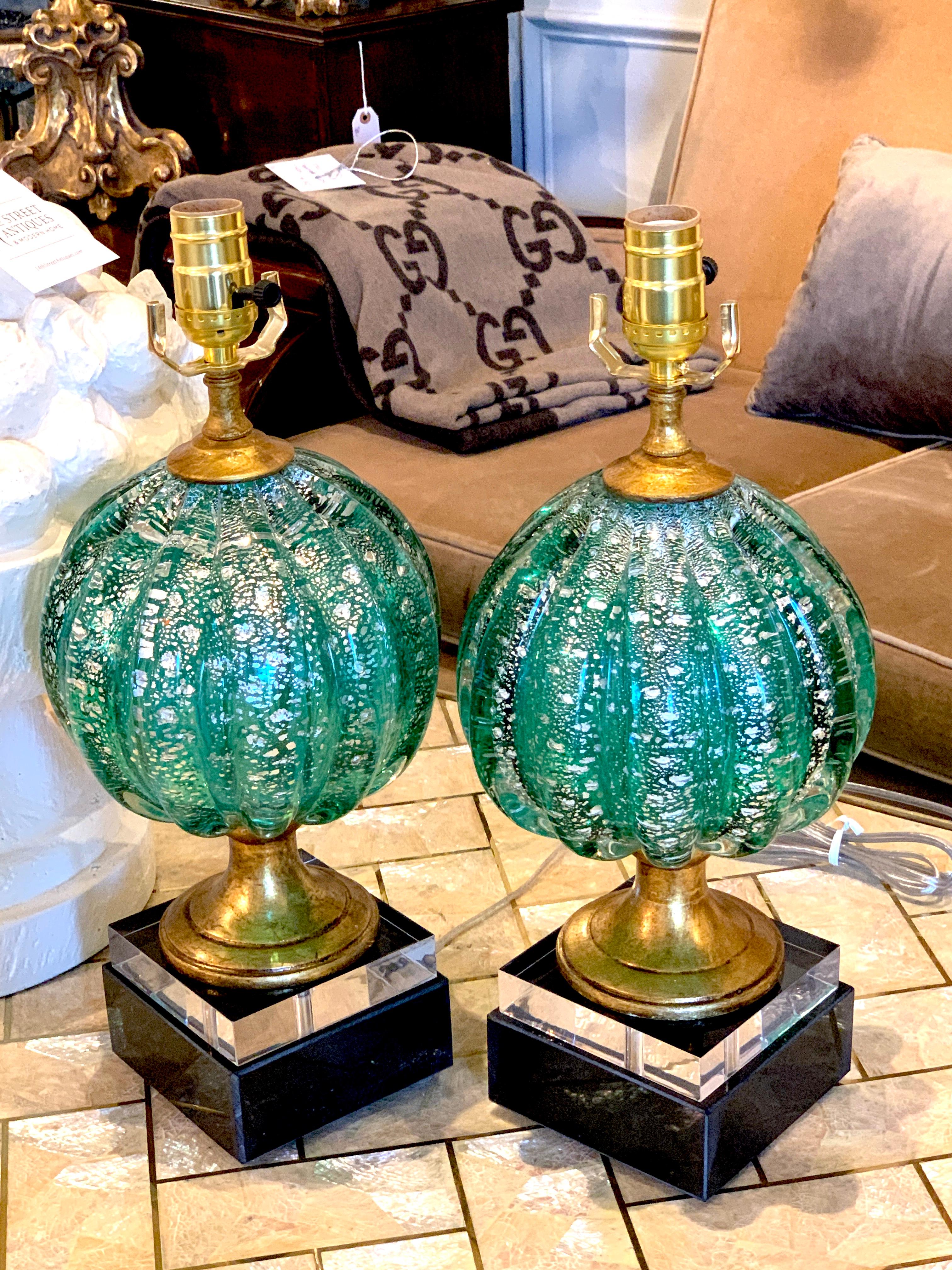 Stunning pair of green and silver infused Murano glass orb lamps, each one magnificent ribbed and luminescent hand blown Murano glass, raised on 5