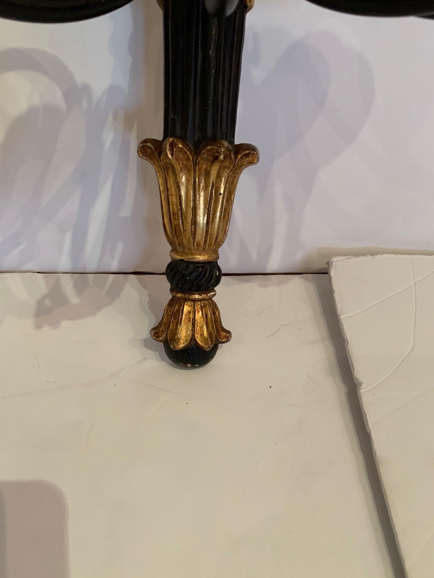 Pair of eye-catching Regency style black and gold sconces having 3 arms each.
Note: we have another pair listed that is slightly different but make a great set of 4.