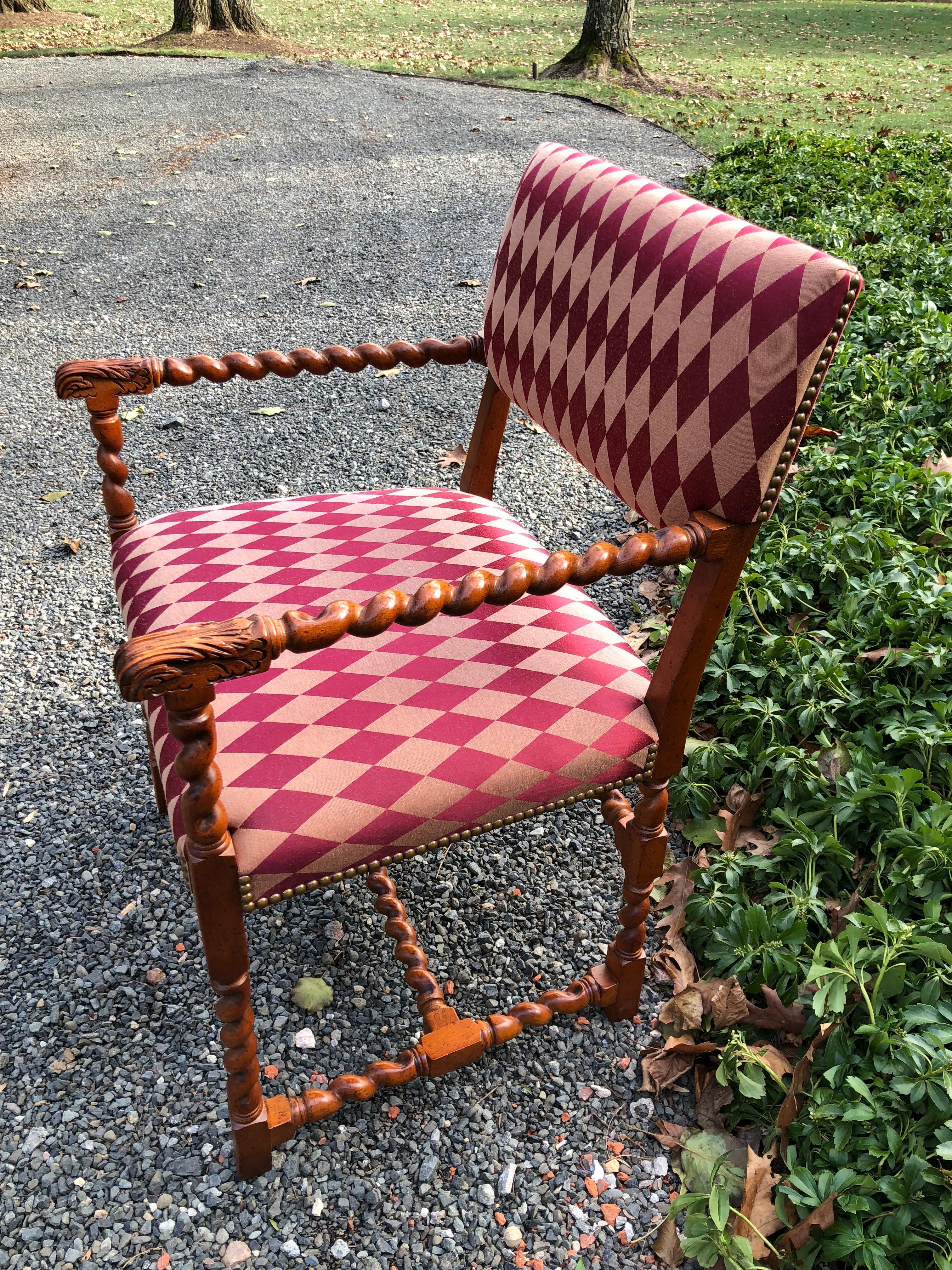 Fabulous pair of Jacobean style walnut hall chairs having barley twist fashioned wood and harlequin patterned silk upholstery trimmed in French brass nail heads. Versatile as accent occasional chairs or hall chairs. Measures: Seat height is 19.5,