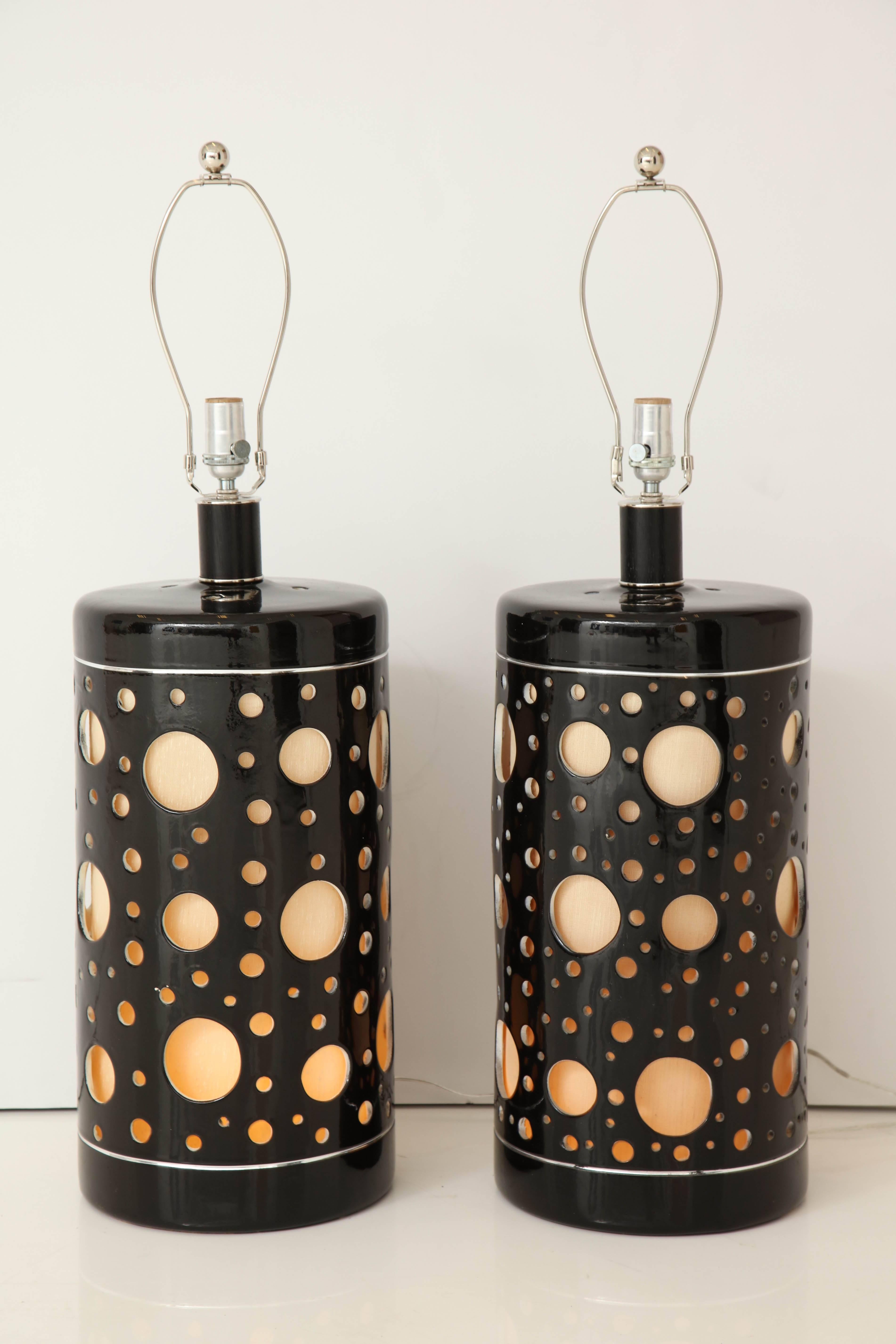 Stunning pair of Iarge 1970's Italian ceramic lamps.
The lamp bodies have varying sized cut out holes which are highlighted by the inner shade which illuminates.
They have been newly rewired for the US and are on a three-way switch.
The height to