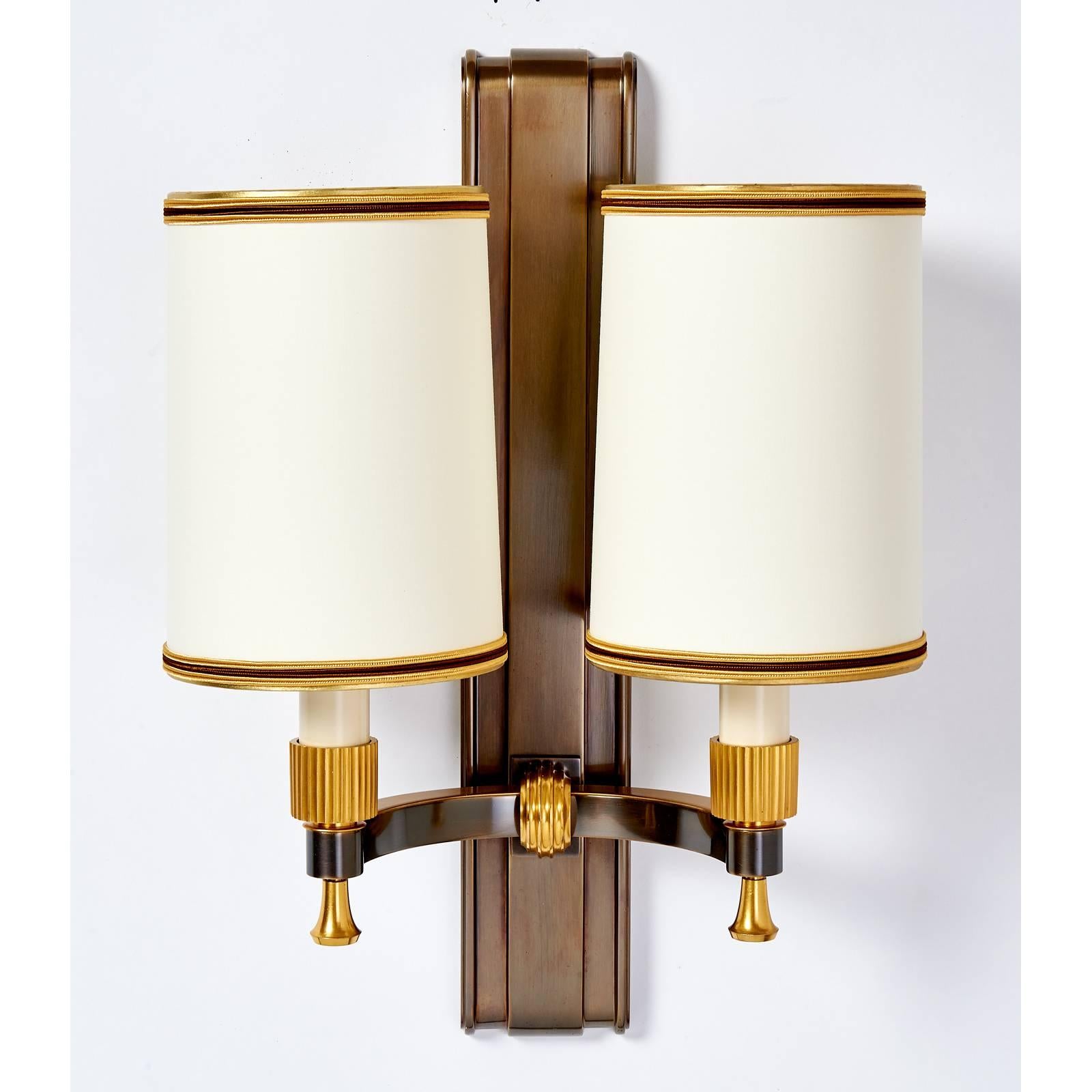 Maxime Old (1910-1991)
Stunning pair of gilt and oxidized bronze sconces with fluted mounts by Maxime Old
France, 1940s
Ref: Yves Badetz, Maxime Old, p.109, for this model
TWO PAIR AVAILABLE  Sold and priced by the pair
Dimensions: 12.5 W x 7.5 D x