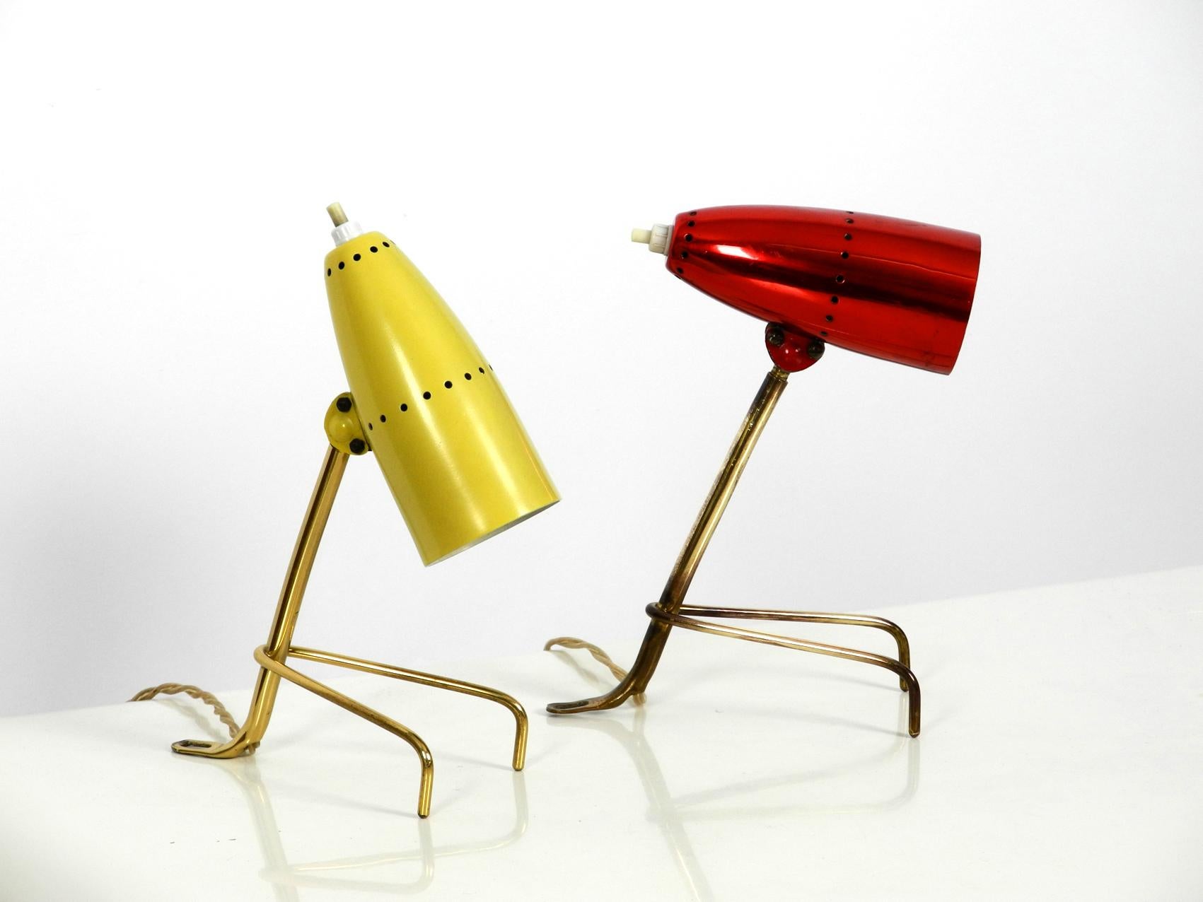 Pair of colorful Mid-Century Modern brass crowfoot table lamps. Made in Austria.
Great rare design with one cherry red and one beige (very light yellowish, not as yellow as in the photos) alu shade. Shades are steplessly movable. They also can be