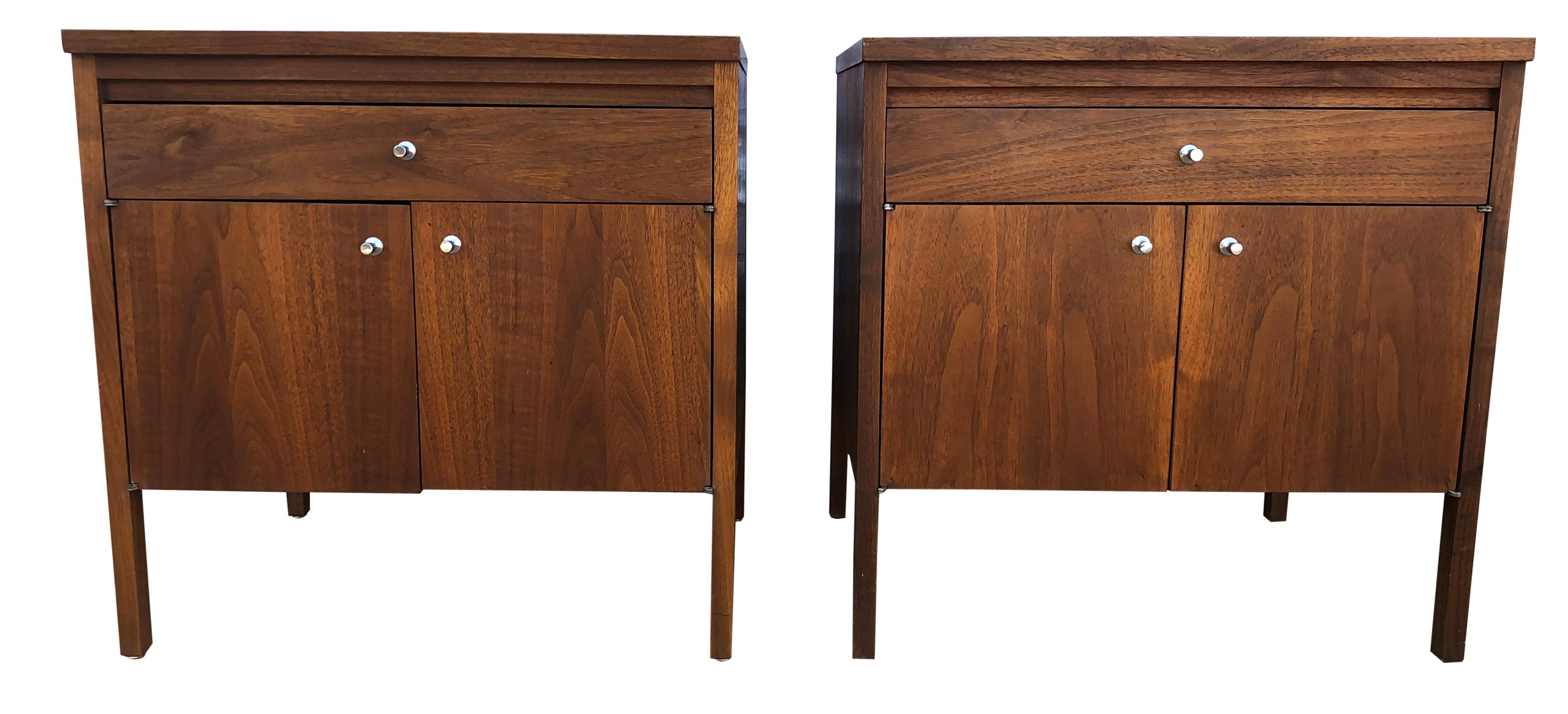 Midcentury American Designer Paul McCobb pair of nightstands small cabinets solid walnut. Original finish in beautiful vintage condition - Has (1) top drawer and (2) lower front cabinet doors - All solid Walnut with joint and grain details - Solid
