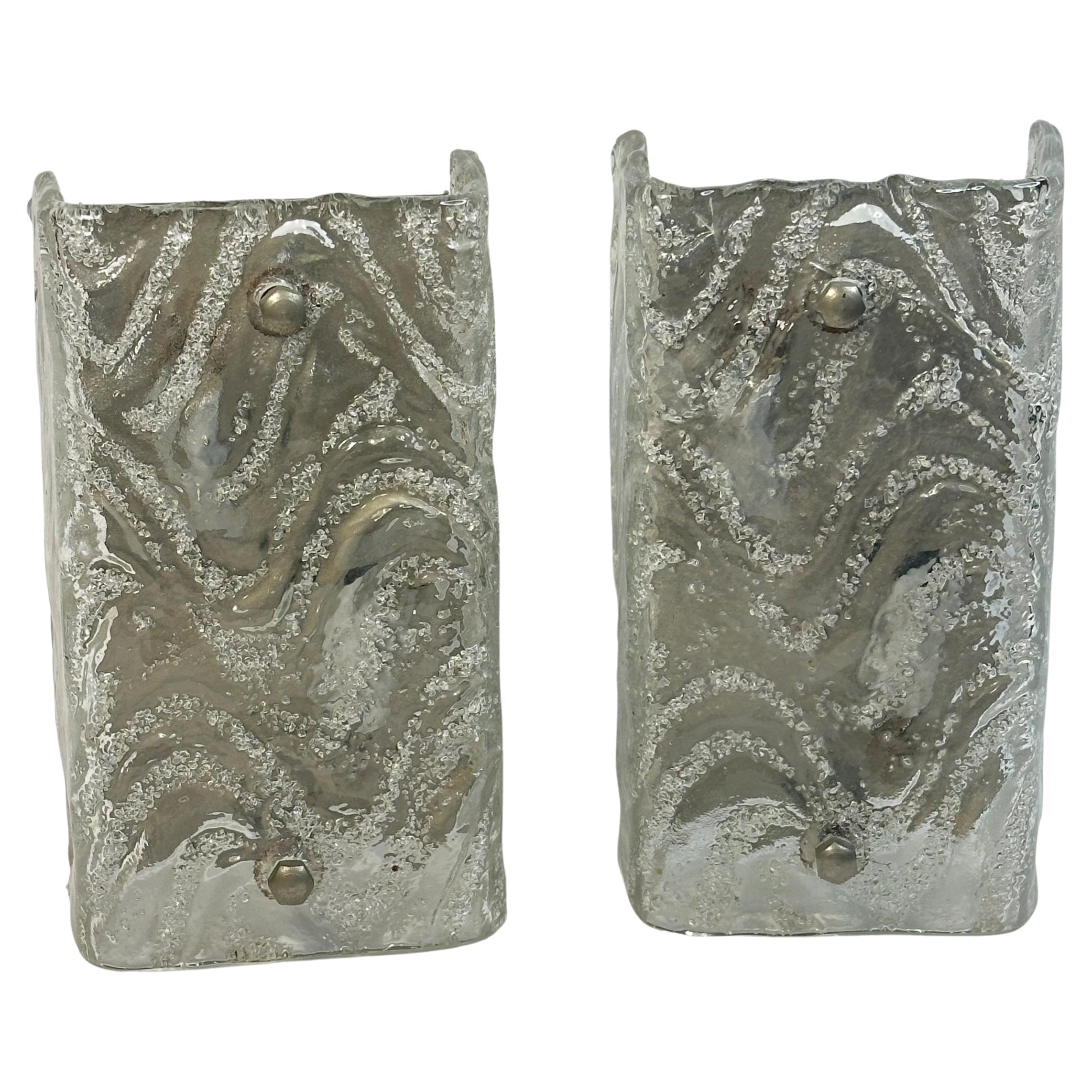 A stunning pair of Murano glass ice block wall sconces. Each consisting of a stylish single ice block design. A single nickel plated wall plate with two sockets on each plate and mount make for a beautiful wall light. Easy to mount and fantastic to