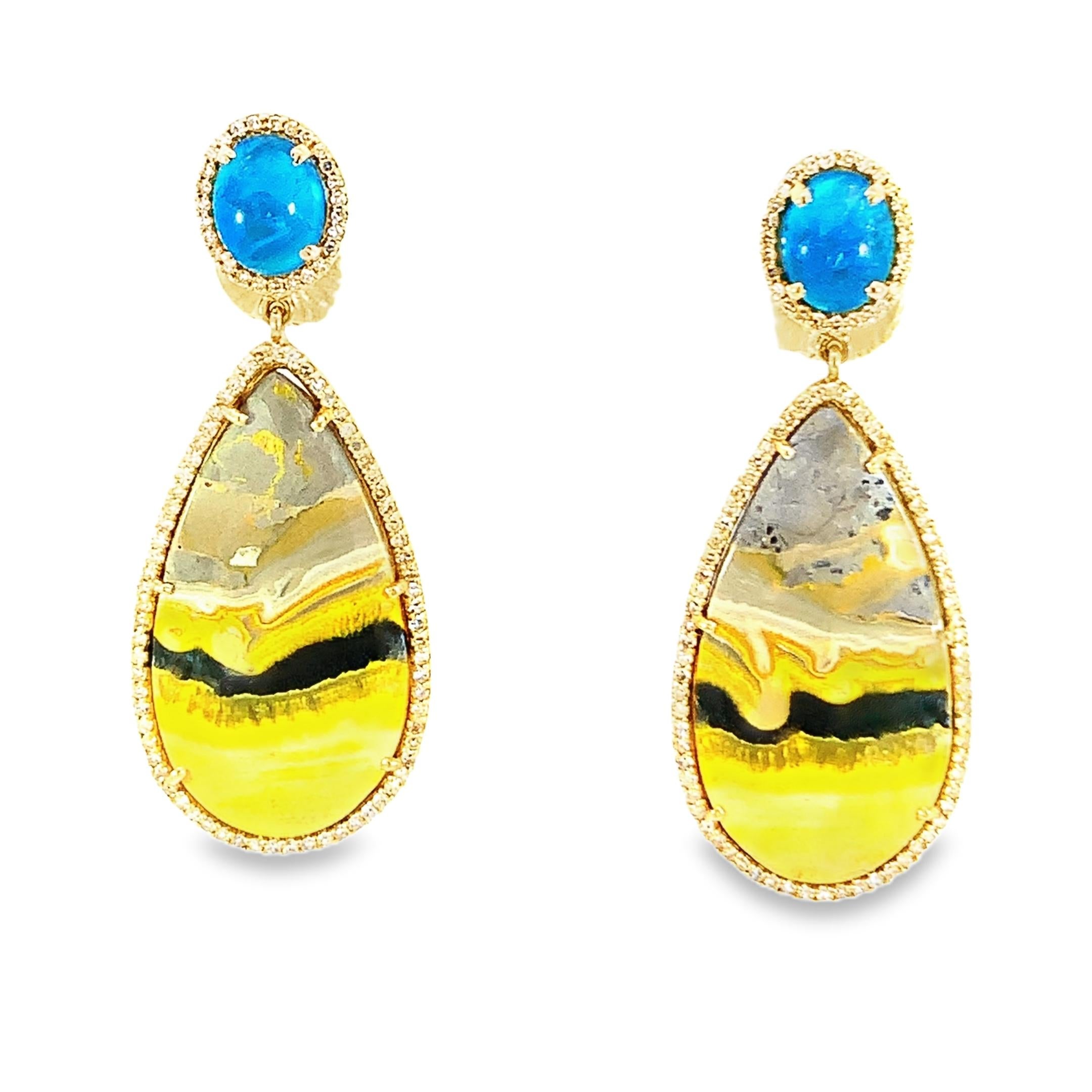 Beautifully framed in 14-karat yellow gold, these teardrop earrings showcase a striking combination of yellow and gray 31.62-carat Bumblebee jasper gemstones. They are ideal for any event because of the stunning 1.22-carat diamond that surrounds the