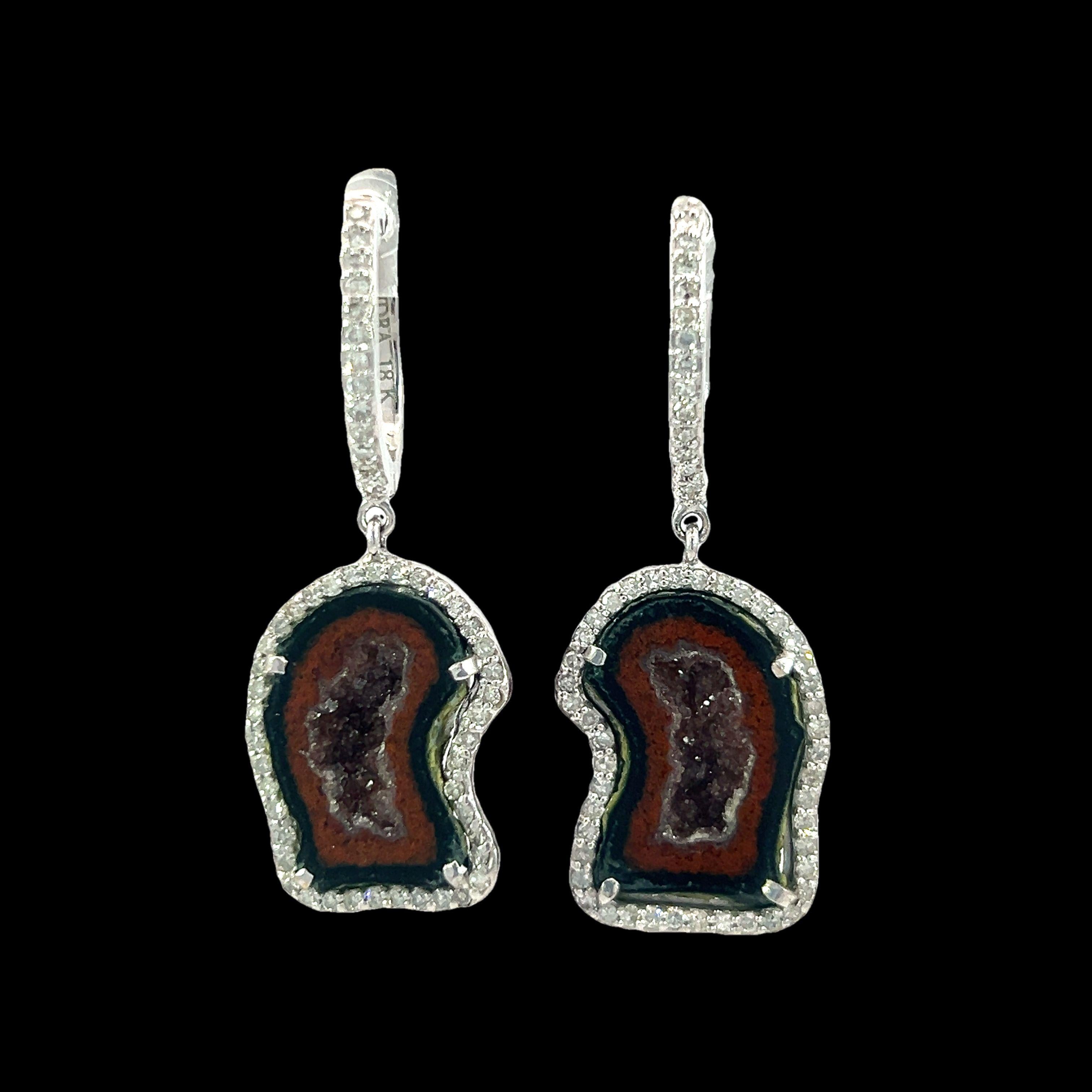 These stunning 12.88-Carat Druzy quartz and 0.67-Carat diamonds earrings feature a unique blend of natural beauty and elegance. The intricate design showcases the raw, earthy charm of druzy quartz encased in a delicate 18Kt white gold setting.