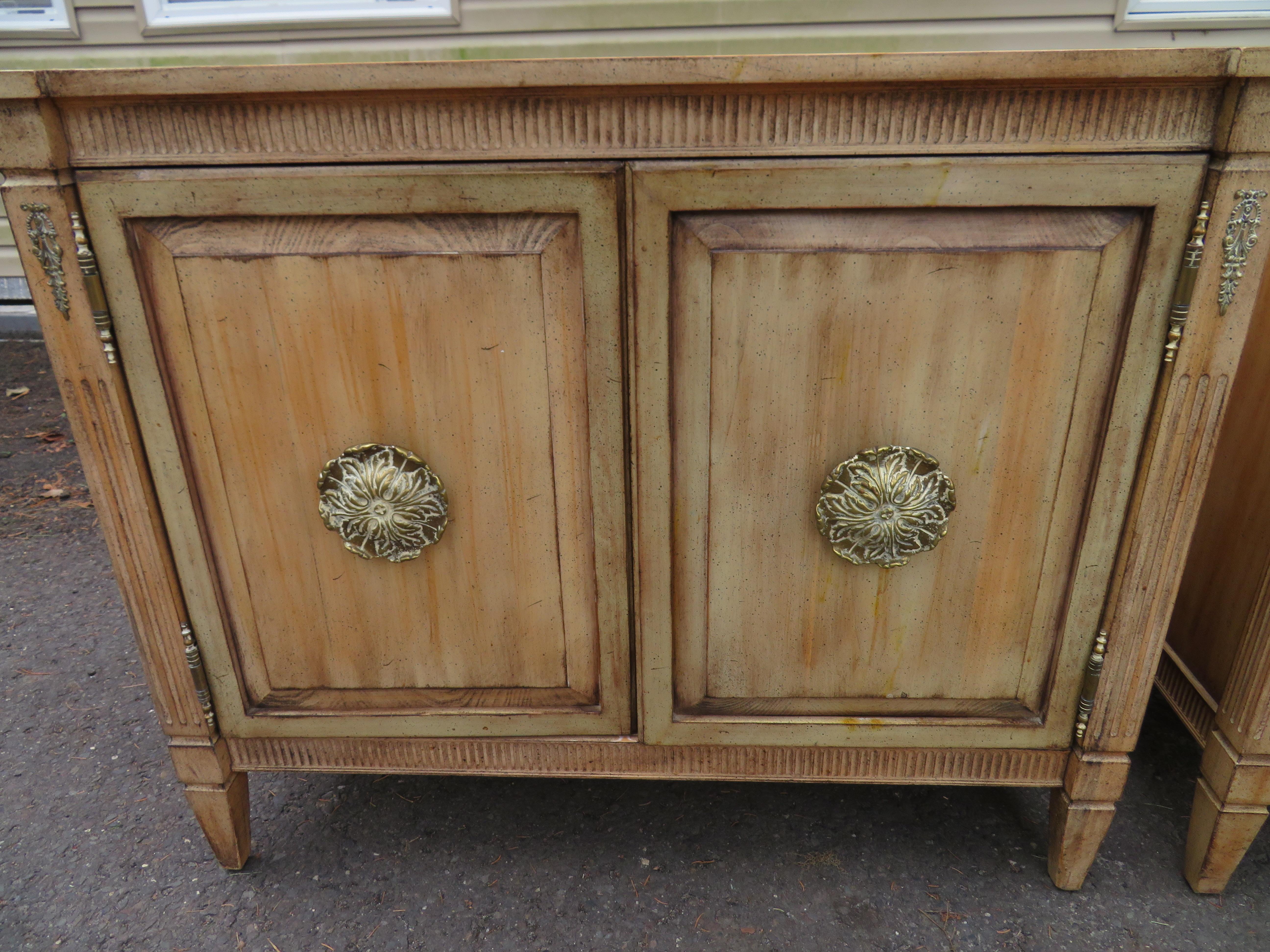 Stunning pair of distressed finish neoclassical bachelors chests. We love the intentionally distressed finish on these against the classical styling of these fine chests. Use as oversized nightstands or anywhere you need matching chests to add