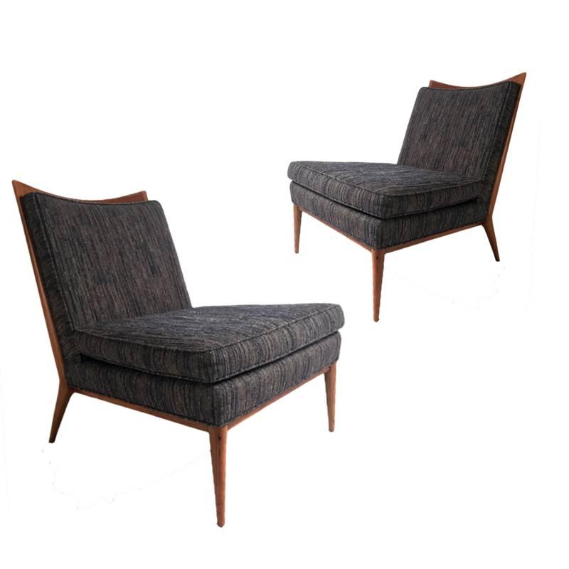 Sleek and streamlined pair of Paul McCobb chairs. Epitome of 1950s modern design. Model 1322 slipper chair. Walnut detail and legs with a lovely midnight blue textured upholstery.
