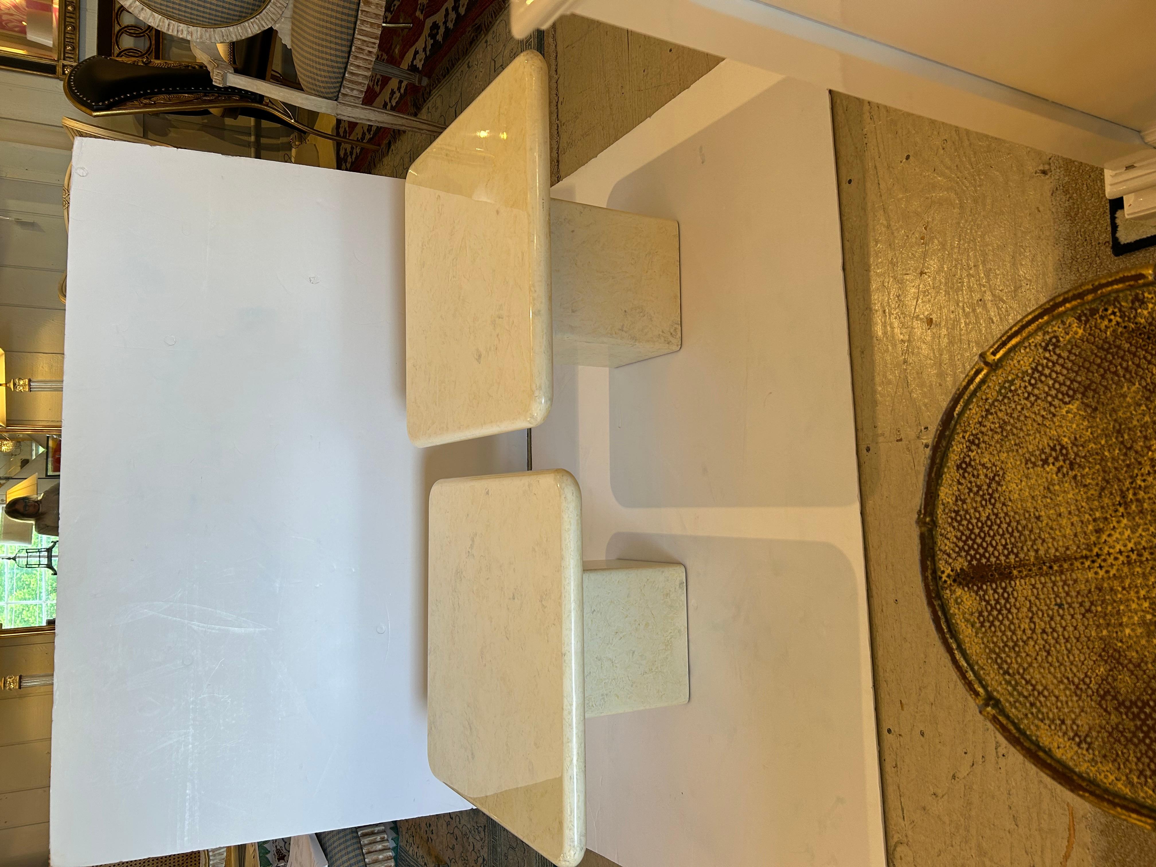 Stylish coffee table made of two beige faux marble laquered square tables, one taller than the other, that create a versatile chic cocktail table.  The pieces can overlap or be used with space between them.
Taller table is 24 square x 16 h
Shorter