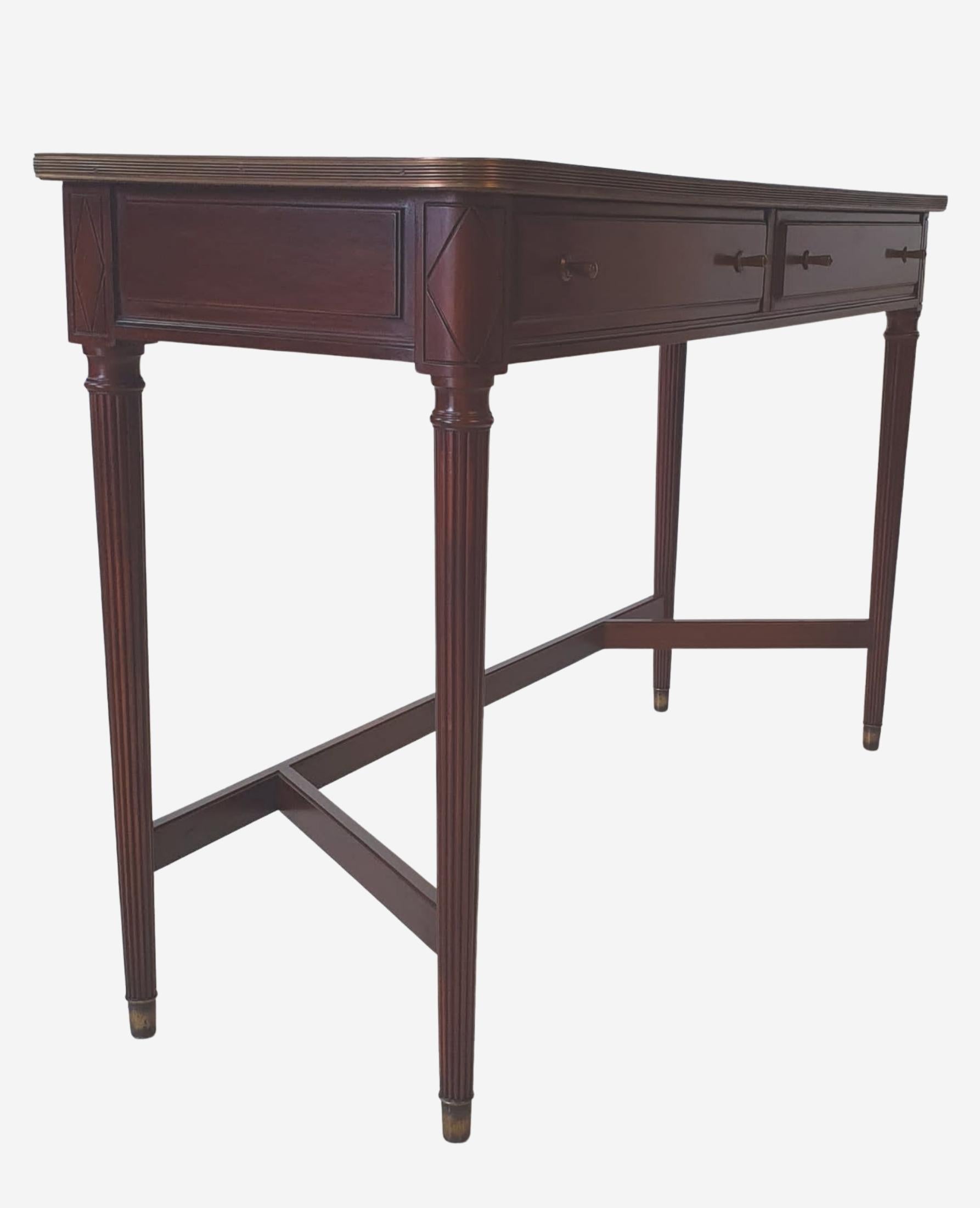 Stunning pair of Twentieth Century mahogany console tables. The figured mahogany moulded tops with brass mounting raised above panelled apron with carved diamond motif and two cockbeaded drawers with brass pulls to the fore supported on turned and