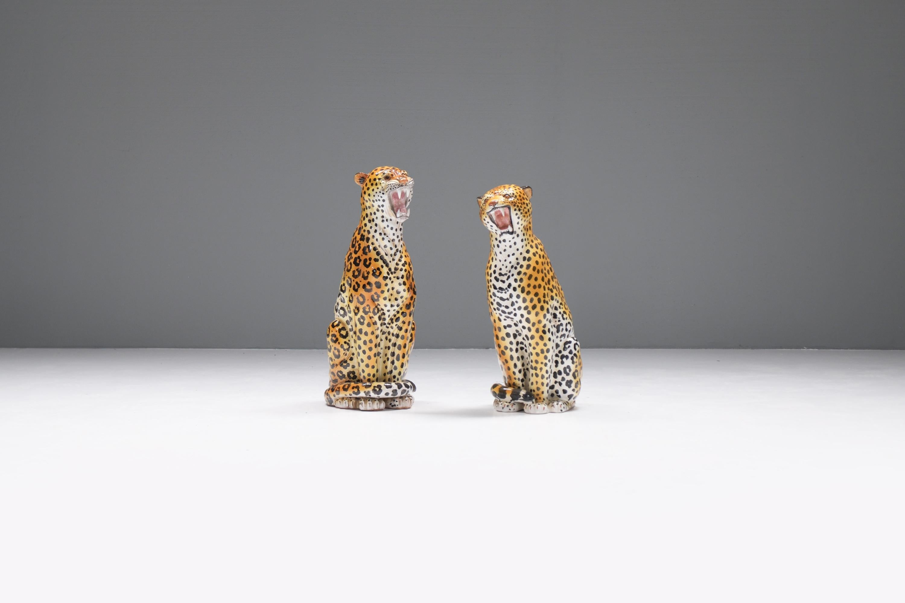 Stunning pair of vintage female and male ceramic leopard sculptures, Italy 1960. 

Beautiful set of two vintage glazed ceramic leopard sculptures.  Made in Italy in the 1960s. 
Both sculptures are large, life size and are in very good condition with