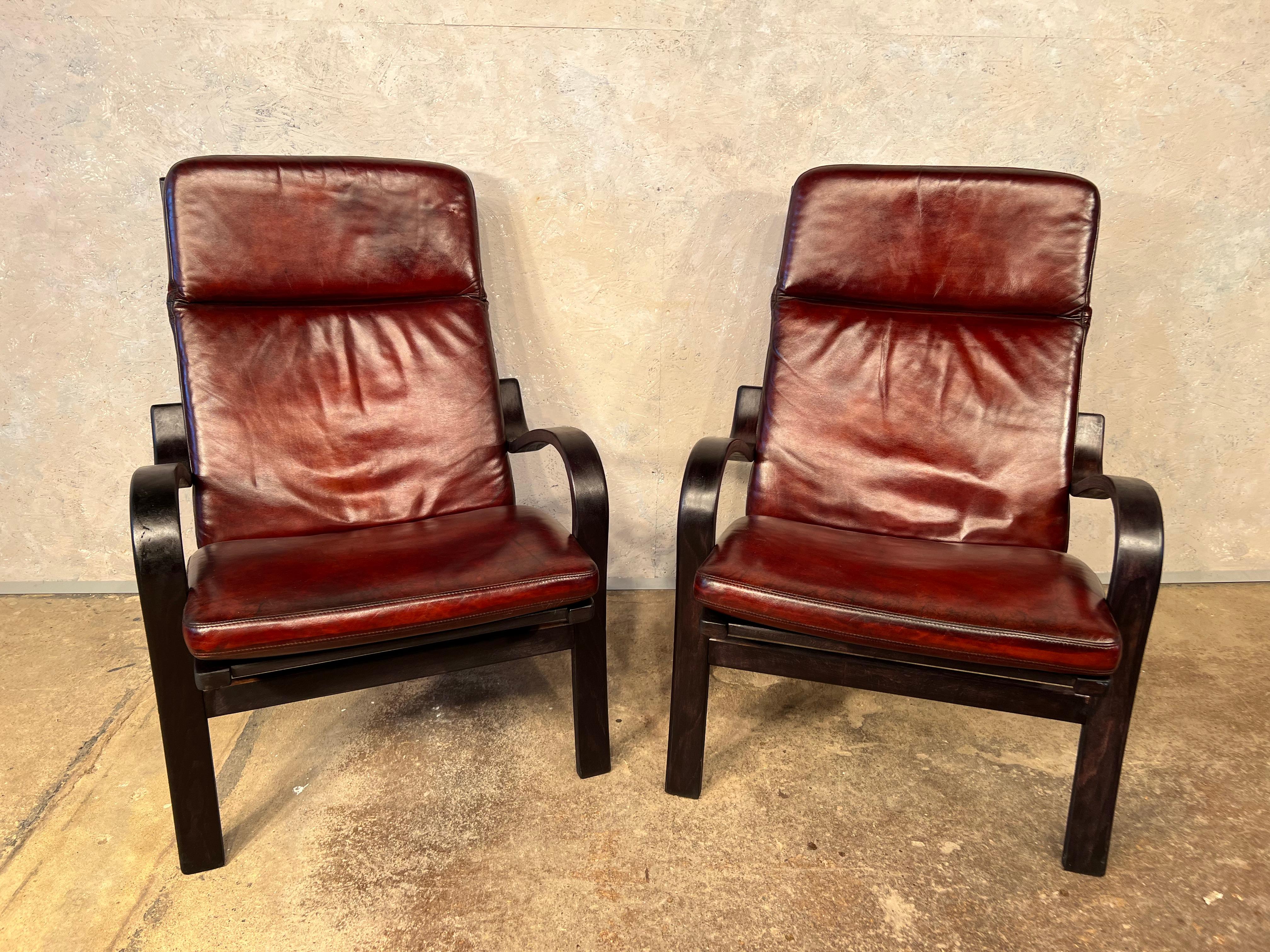 A stylish Pair of 70s Vintage Danish bentwood and leather chairs, a beautiful contrast between the ebonised bentwood frame and the deep chestnut hand dyed leather cushions, very sleek design, great patina and finish. In great vintage condition,