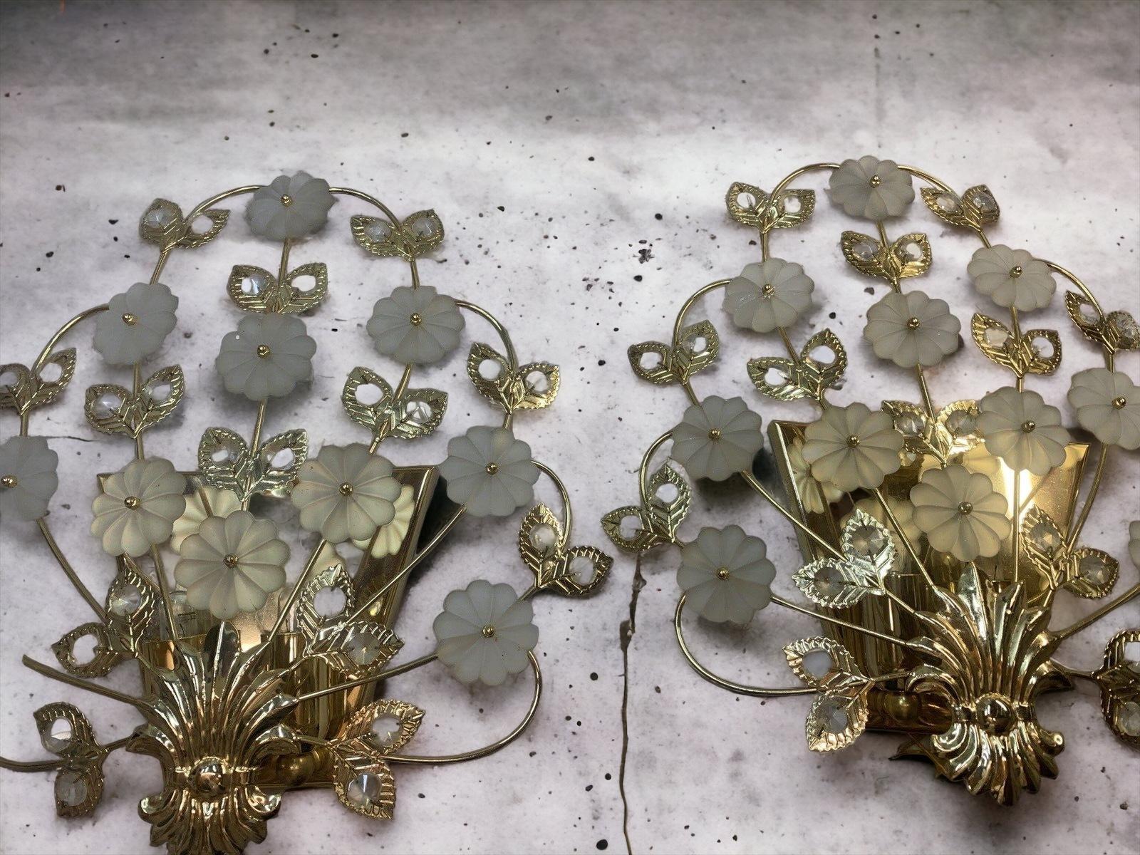 Pair of vintage two light sconces with faceted crystals and glass flowers made by the German company Palwa. Each fixture has two European style E14 sockets. Each requires two European E14 candelabra bulbs, up to 40 Watts each. A nice addition to any
