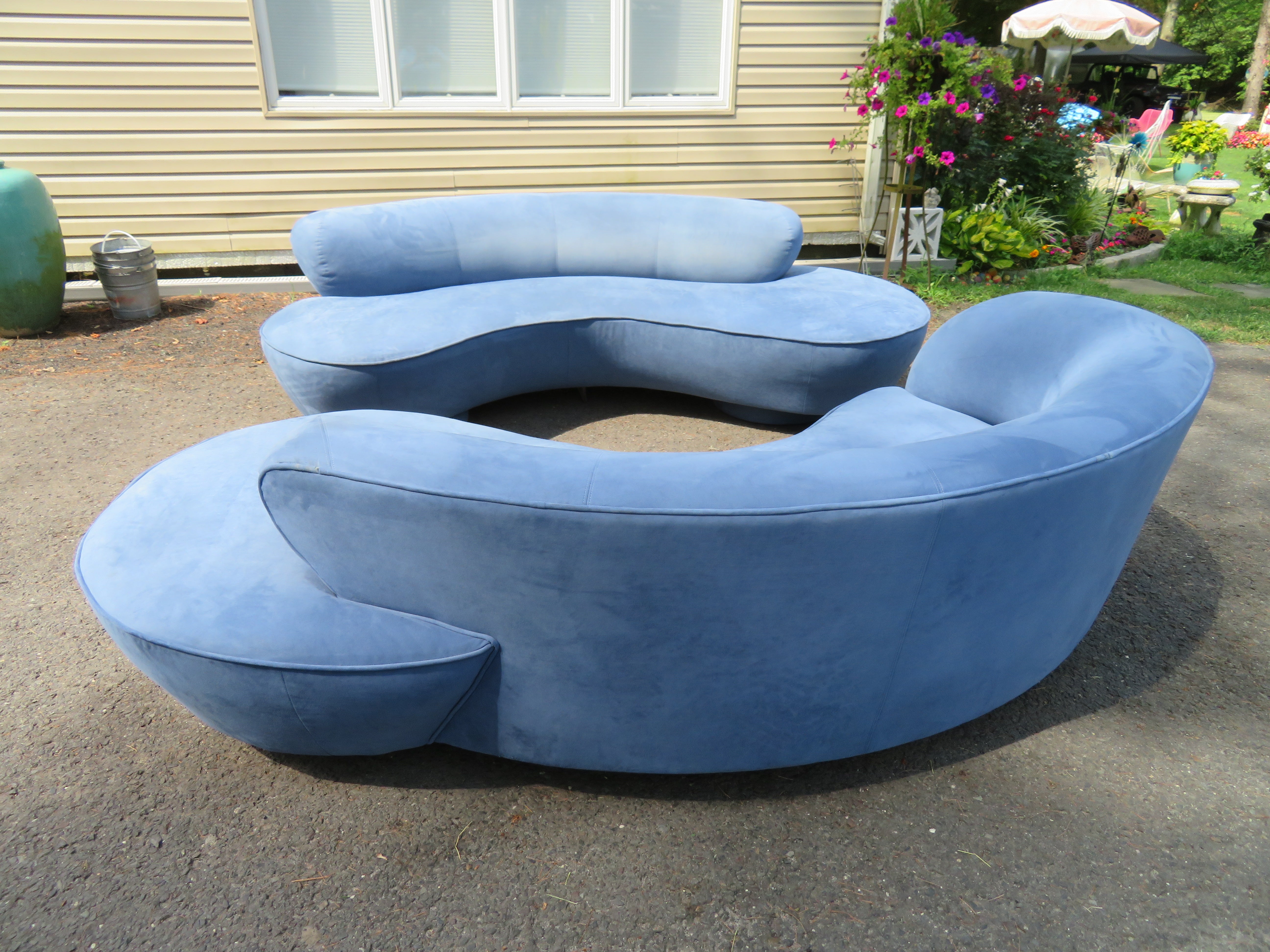 Fabulous pair of Vladimir Kagan cloud serpentine sofas made by Directional. These pair retain their original periwinkle blue ultra-suede fabric in nice vintage condition-some wear spots on a back cushion of one-see photos. Very usable and