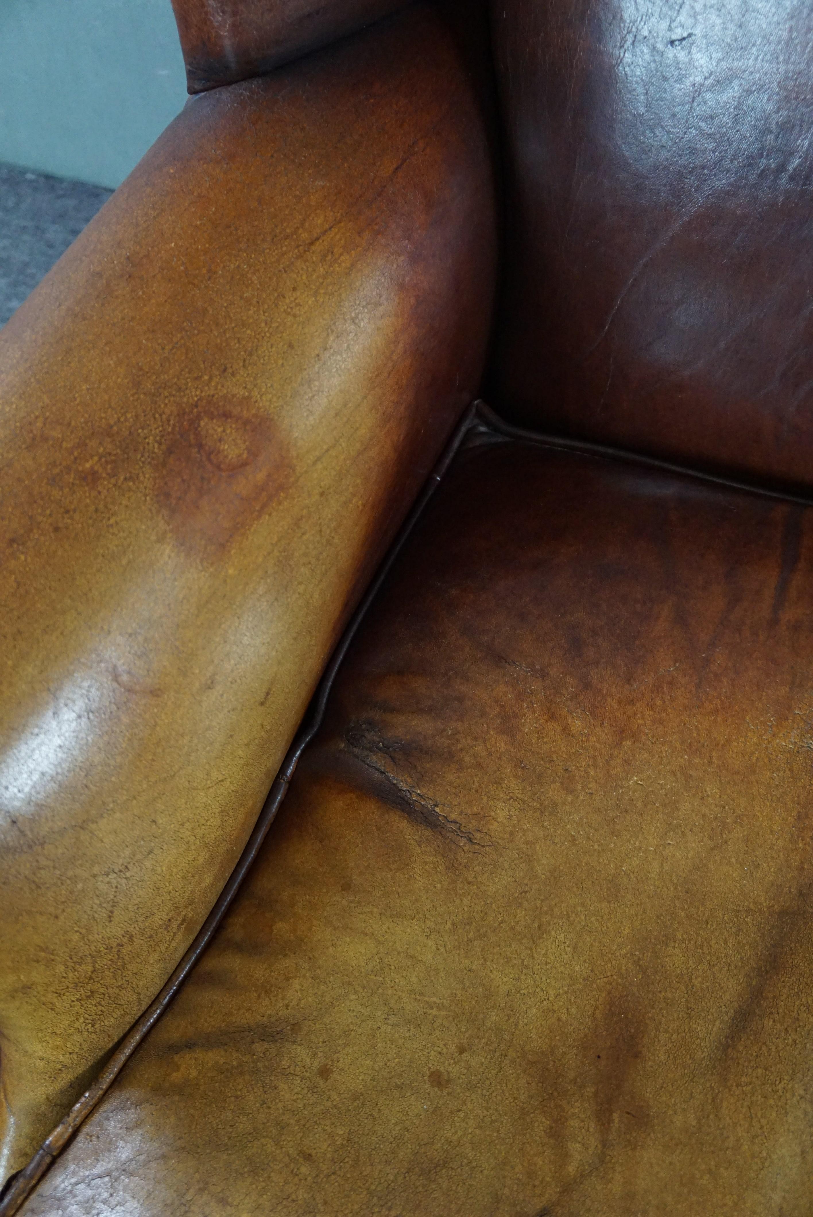 Leather Stunning patinated sheepskin leather wing chair For Sale