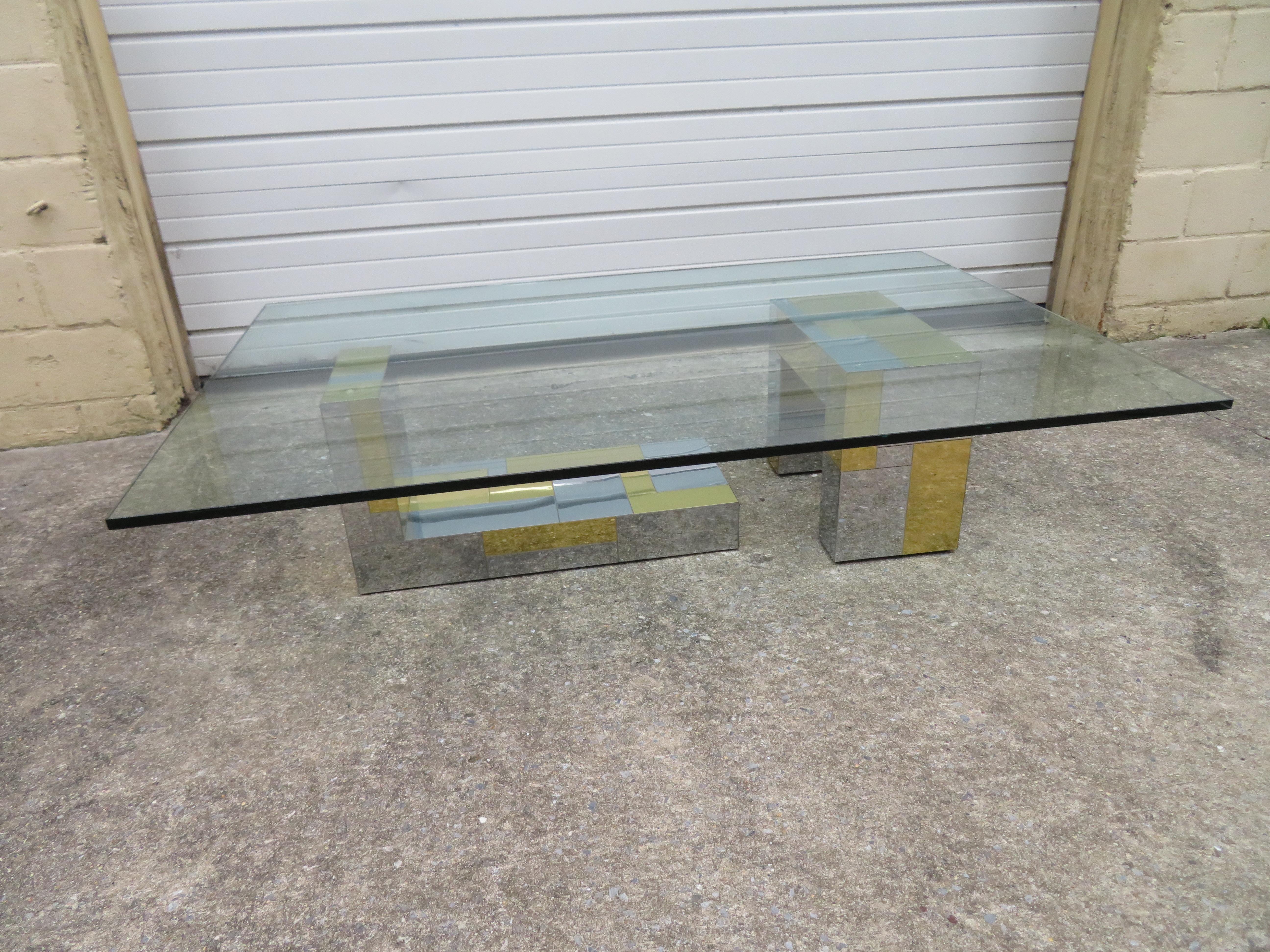 Fabulous Paul Evans for Directional brass and chromed steel coffee table consisting of two sculptural bases supporting an over sized glass top. This particular table is not signed but the original owner did have the original catalog photo from