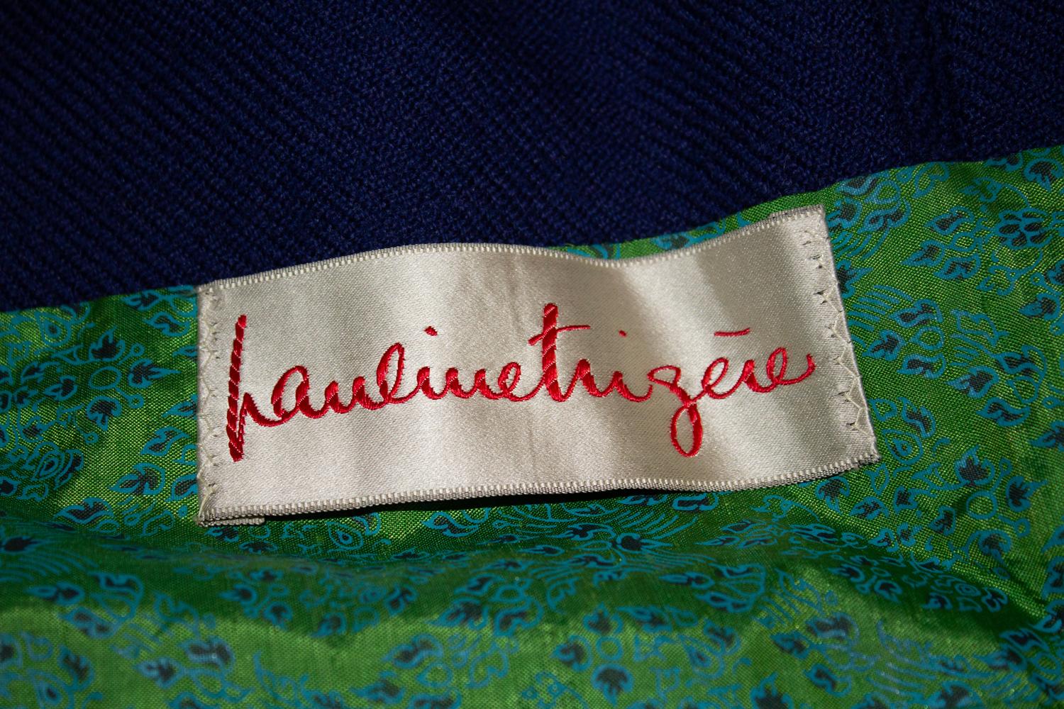 A headturning vintage coat by Pauline Trigere, stocked in Amelia Gray, Beverly Hills , California.
The coat is in a blue wool , with attractive green and blue lining. It fastens with hidden poppers and one decorative button.  The coat has a round