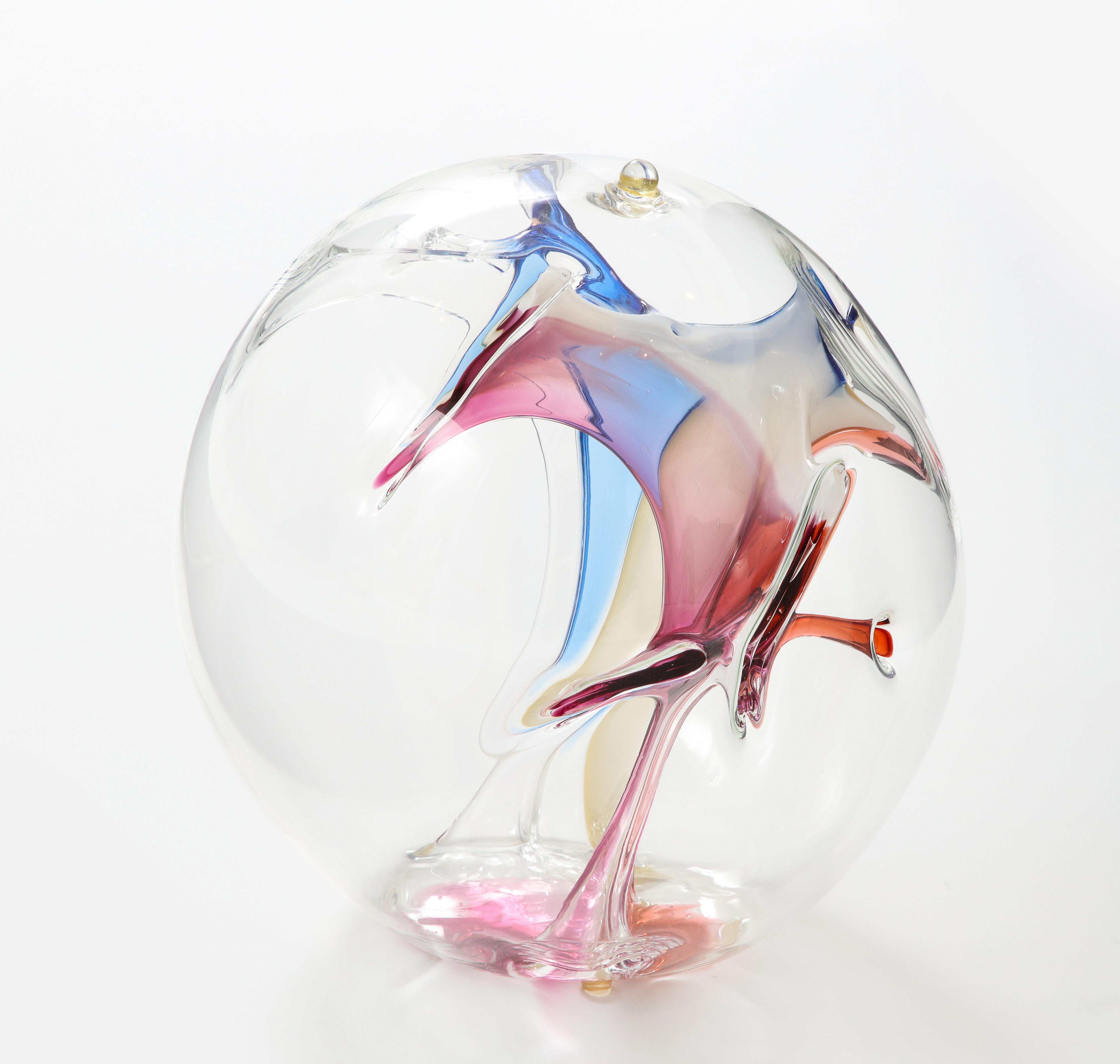 Stunning Glass orb sculpture by Peter Bramhall.
The hand blown glass sculpture has internal glass threads in Blue, Magenta, Clear and champagne tones.
It is signed and dated on the bottom.
