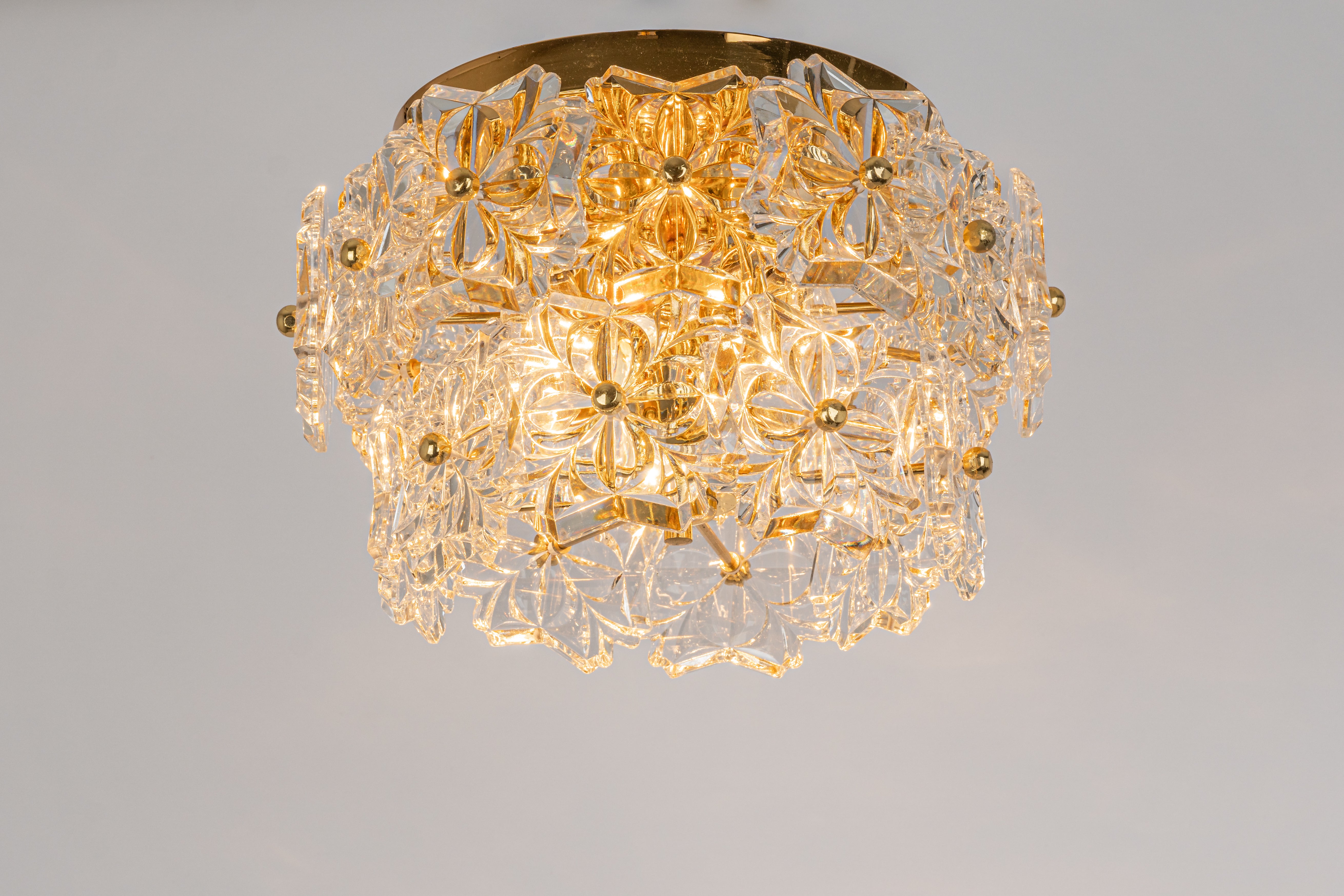 A stunning three-tier chandelier by Sölken Leuchten, Germany, was manufactured circa 1970-1979. A handmade and high-quality piece. The ceiling fixture and the frame are made of gilt brass with lots of facetted crystal glass elements.


High