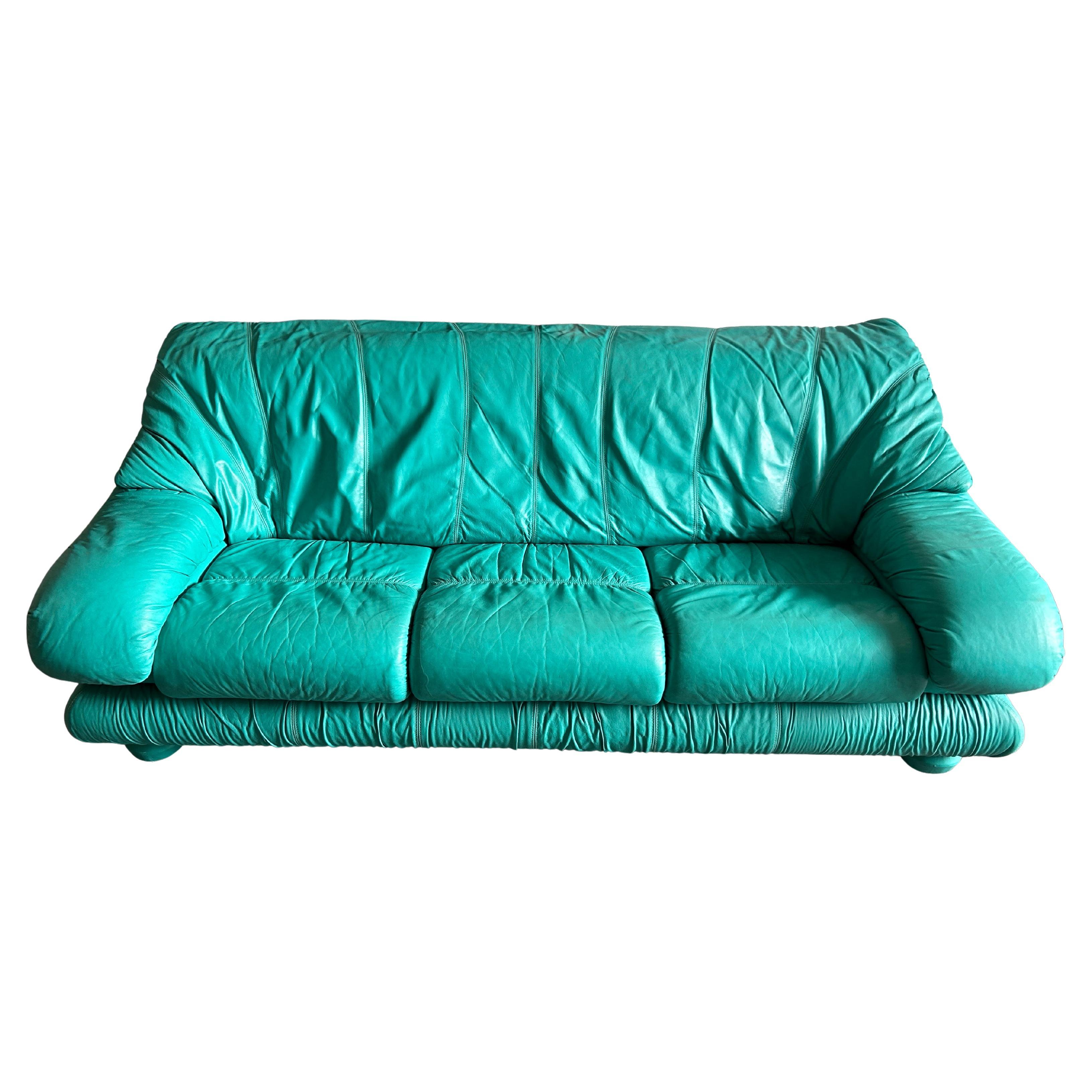 Magical Post modern Teal puffy leather 3 cushion sofa. This sofa has an adjustable back headrest that has 3 positions. This sofa in excellent condition all around shows very little wear. Leather is soft and smooth foam is in great condition. The