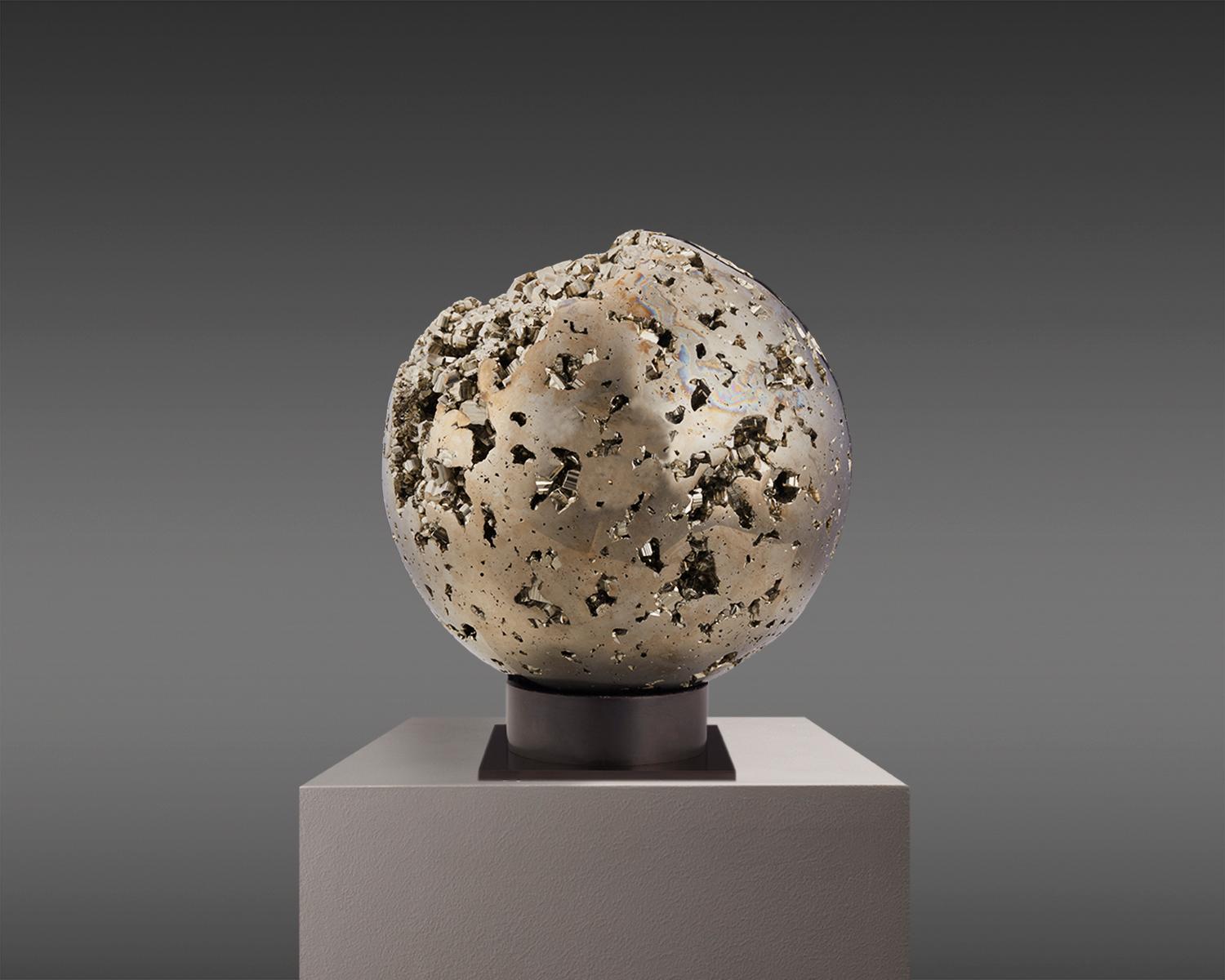 Captivating Pyrite sphere from Peru, a true natural masterpiece. This sphere is a polished marvel, with countless tiny Pyrite crystals embedded within, each sparkling with perfect luster. 

The way in which the crystals catch the light creates a