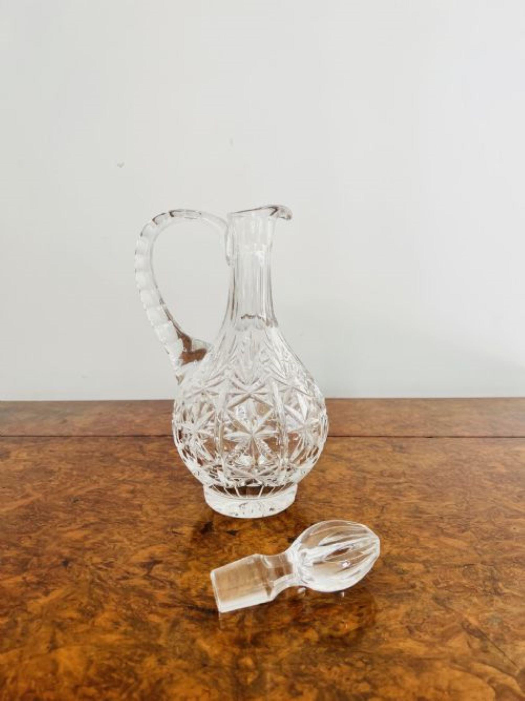 Stunning quality antique Edwardian cut glass ewer having a quality antique Edwardian cut glass ewer with a shaped handle to the back and the original cut glass stopper.