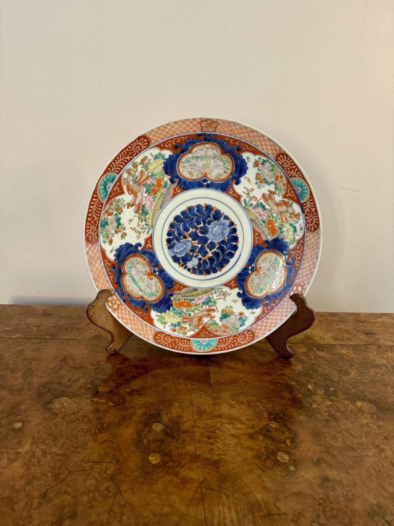 Stunning quality antique Japanese imari porcelain large plate, having a large antique Japanese imari plate, decorated with flowers and leaves in a circular centre in wonderful blue and red colours, surrounded by panels with birds, trees, flowers and