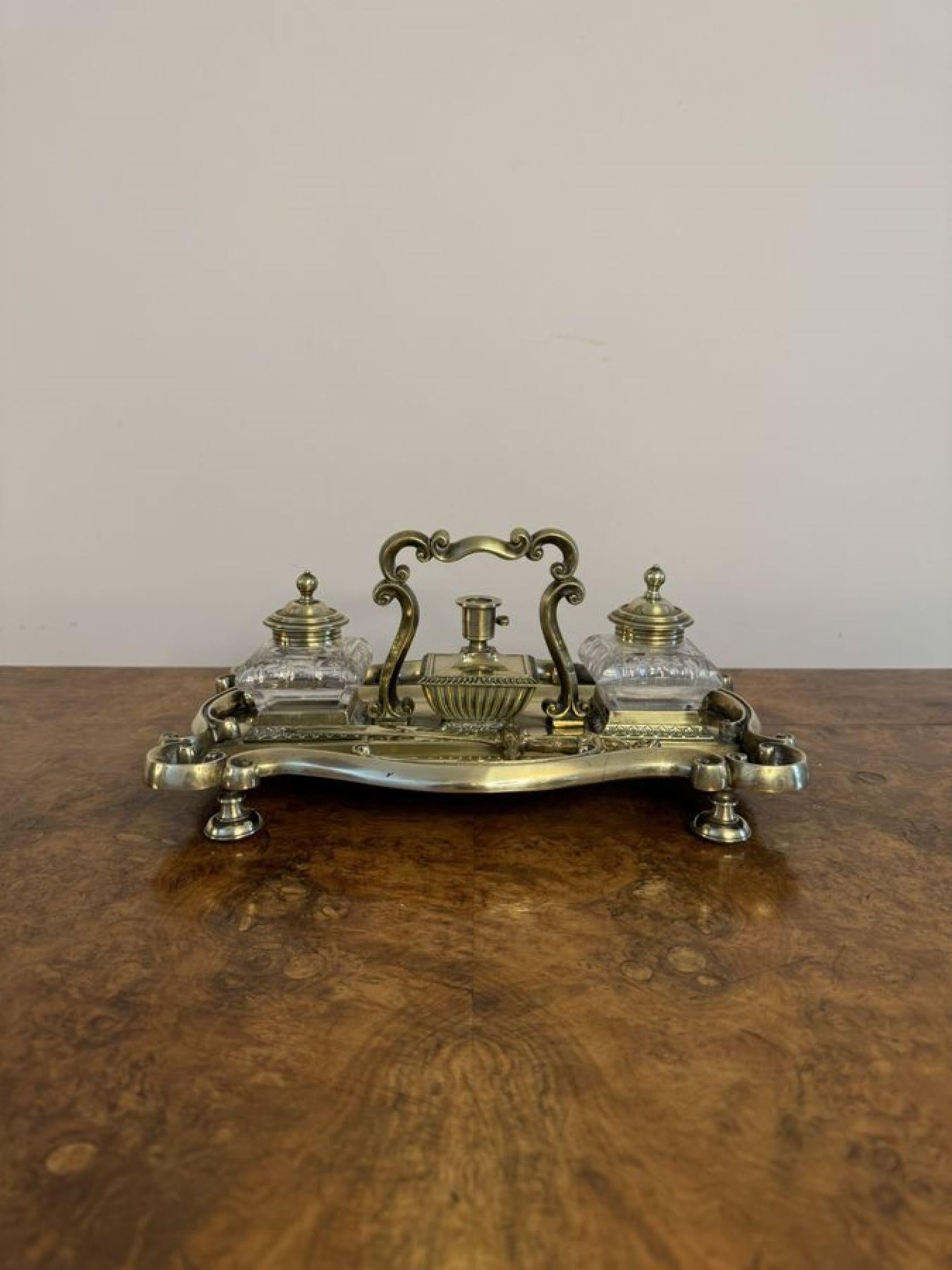 Stunning quality antique Victorian brass desk set having a quality antique Victorian brass desk set with a tray to the front and back, a shaped carrying handle to the centre, the original glass inkwells with removable brass tops, a candle holder and