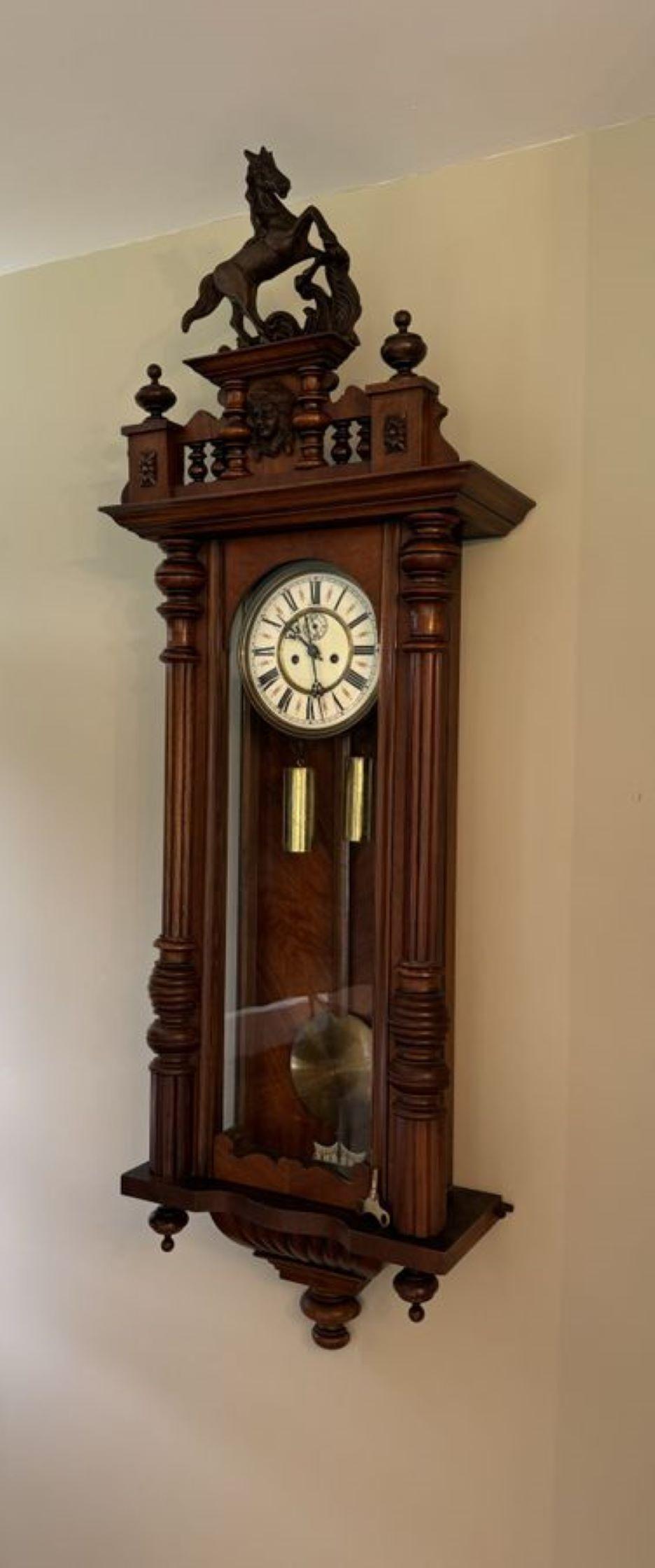 Stunning quality antique Victorian carved walnut Vienna wall clock having a quality carved walnut case with reeded turned columns, having all the original finales, fantastic shaped top finished with a carved horse finale to the top and a shaped