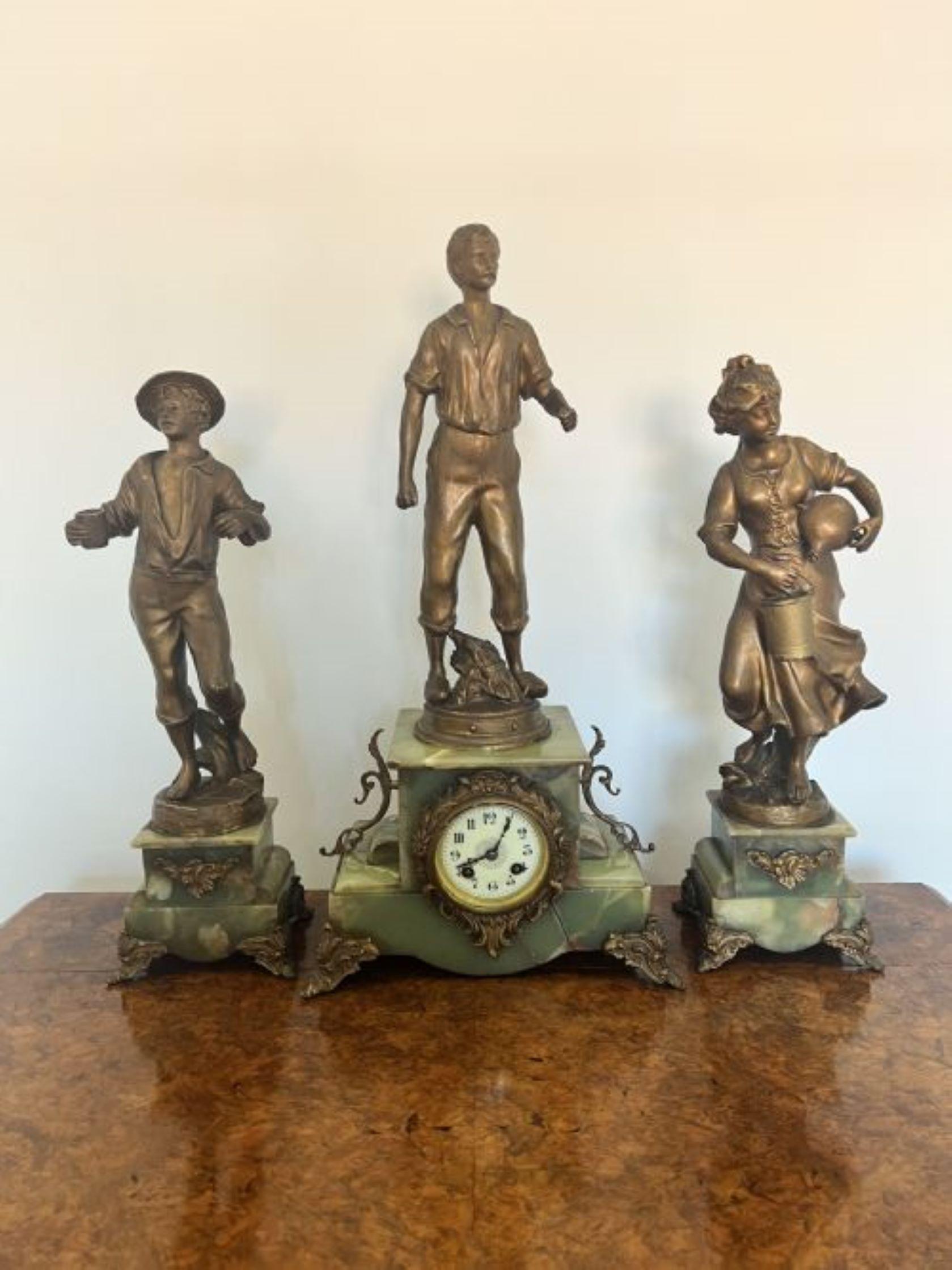 Stunning quality antique Victorian French clock garniture having a quality antique Victorian clock garniture with fantastic onyx and ornate gilt metal mounts, set with farmers to the top of an onyx and gilt metal base with a white porcelain dial,