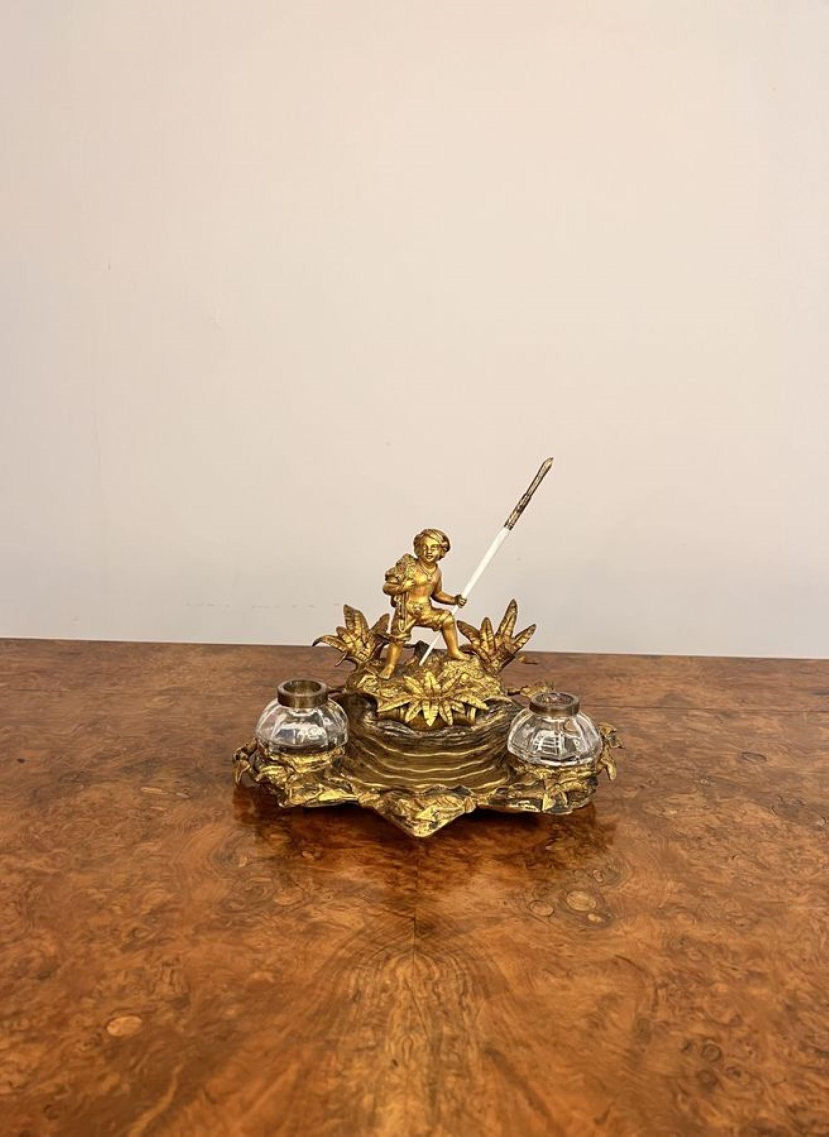 Stunning quality antique Victorian French Ormolu desk set, having a figure to the top on a desert island surrounded by foliage, having a shaped tray with two detachable inkwells.

D. 1860