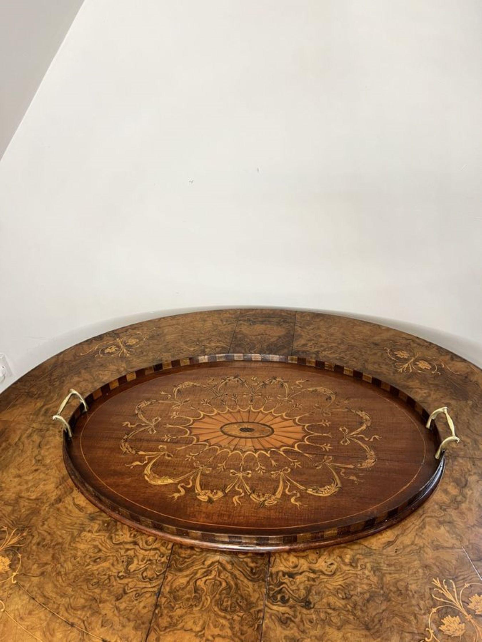 Stunning quality antique Victorian mahogany inlaid tea tray having a stunning antique mahogany inlaid tea tray, with fantastic inlay to the centre of the tray with bows, flowers and leaves, with a gallery edge and the original brass carrying handles