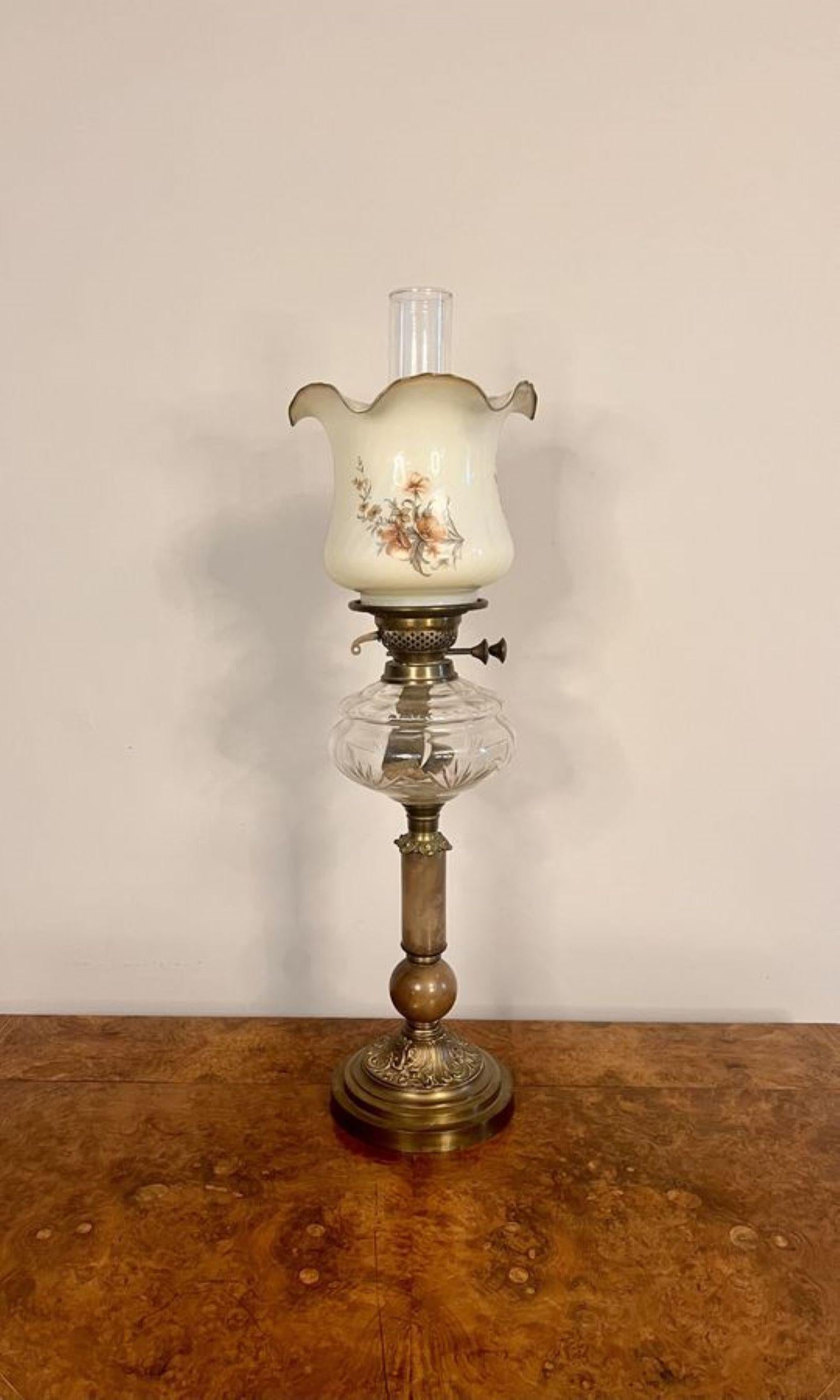 Stunning quality antique Victorian oil lamp, having an original glass chimney and a floral wavy shaped top shade, original brass burner, clear glass reservoir supported on a onyx corinthian column with brass capitals standing on a ornate brass