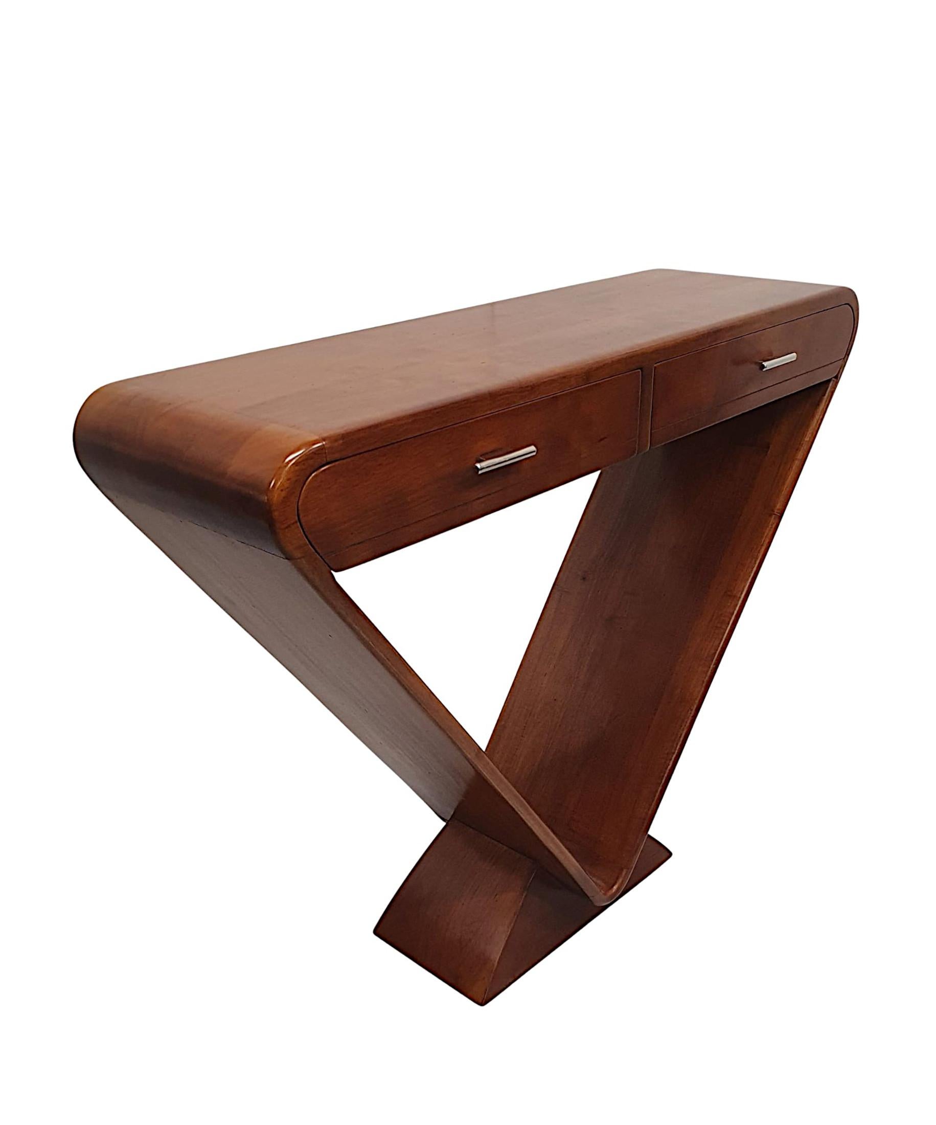 A stunning quality cherrywood console table in the Art Deco style with a curvilinear, clean design and a superb patina to the wood. The moulded curved top raised over frieze with two drawers with pulls above a minimalist triangular shaped support,