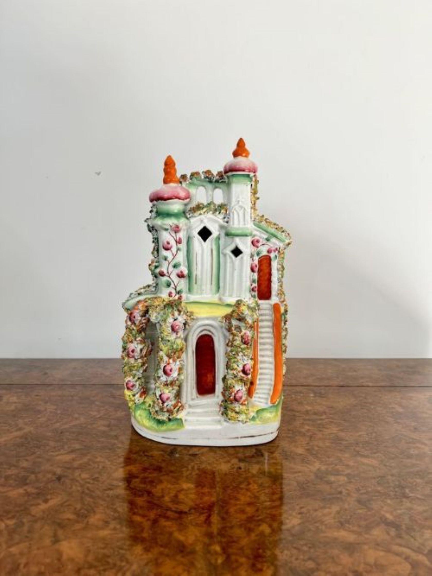 Stunning quality large antique Victorian Staffordshire cottage having a large antique Victorian Staffordshire model of a cottage hand painted in vibrant green, pink, orange, yellow and white colours standing on an oval gilded base. 
