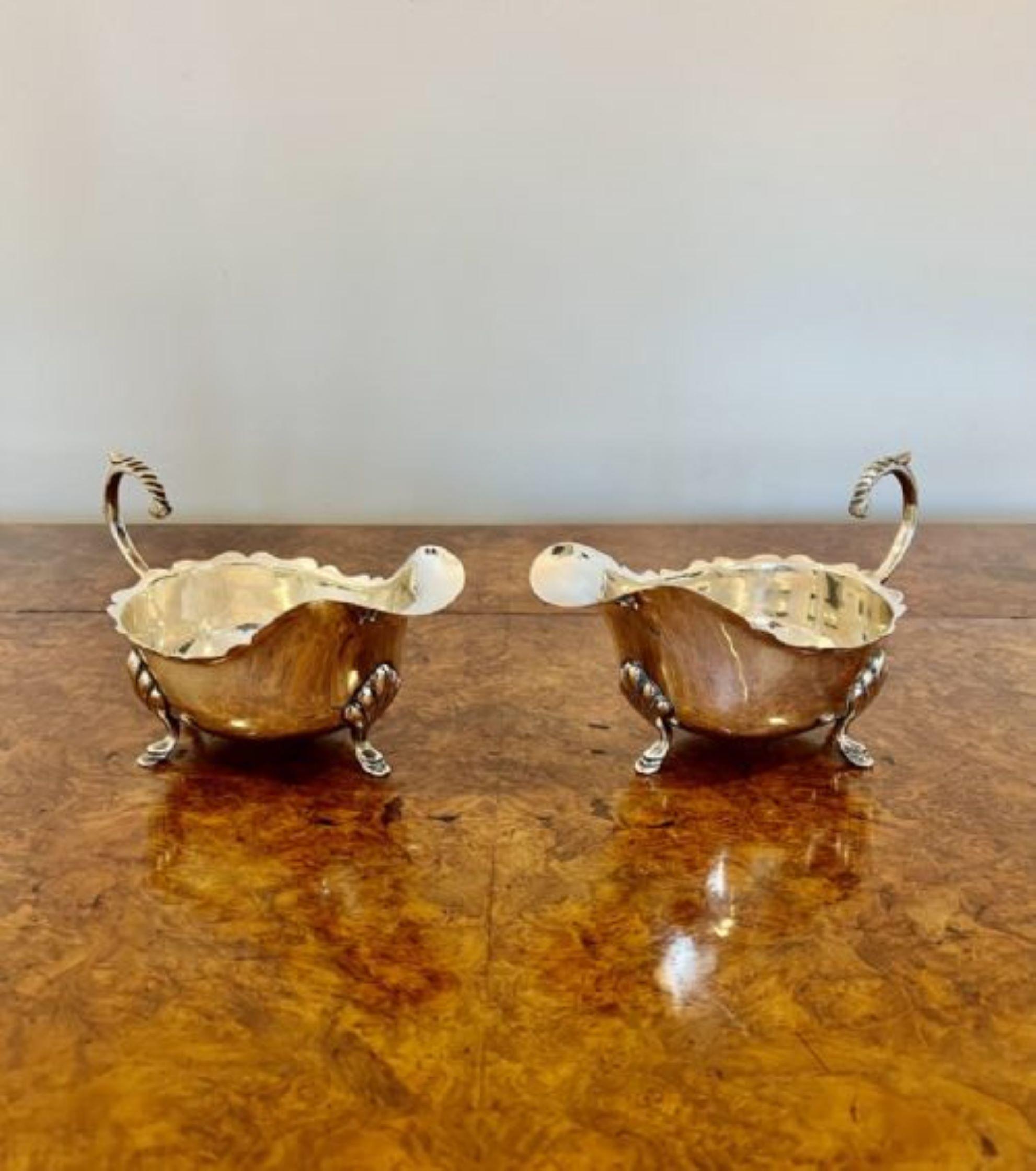 Stunning quality pair of antique Edwardian silver plated sauce boats having a stunning pair of antique Edwardian sauce boats with shaped handles to the back, shaped spout to the front, a wavy edge with a nice shaped body standing on three ornate