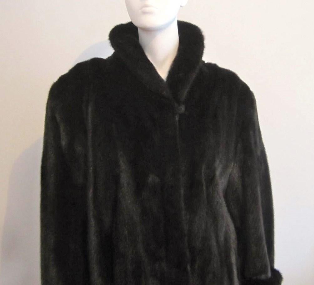 Another stunning almost black ranch mink coat. Luscious mink pelts, French hem, 2 clip closure and a button close to the neckline. Monogrammed inside on a plain brown lining. Measuring Up to a 50in. Bust, Up to a 52in. Waist, Open hips, Length from