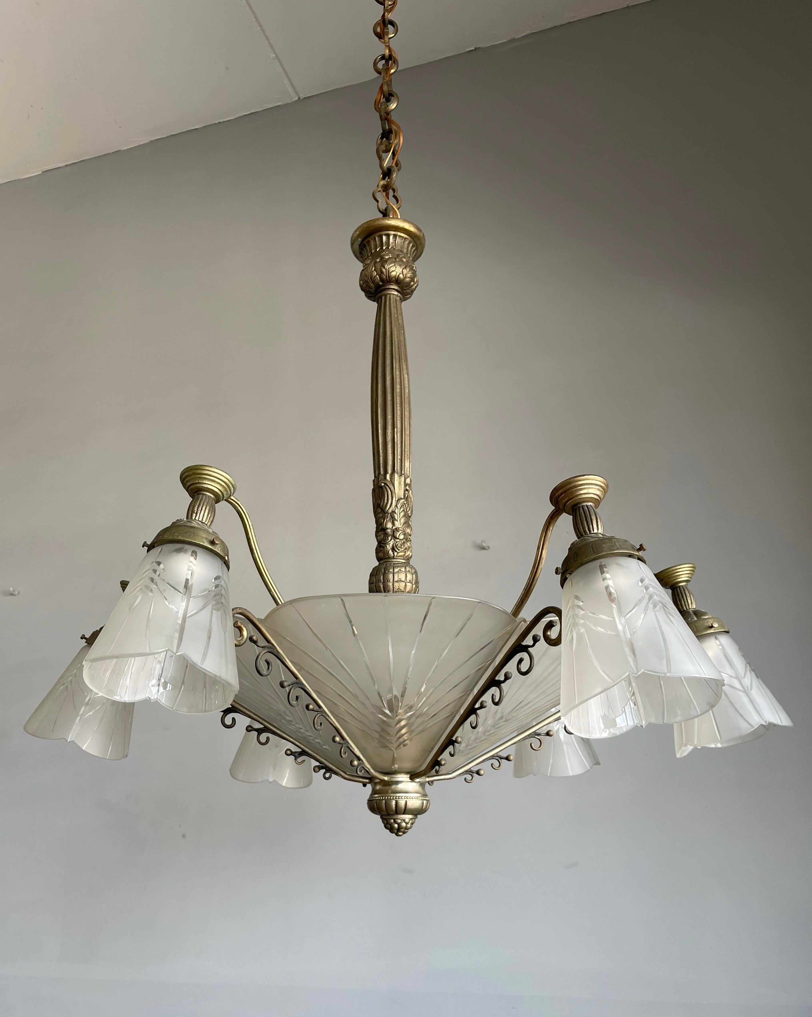 Another bargain for the collectors of top quality Art Deco pendants.

This early 1900s, practical size, bronze and engraved glass 9-light chandelier with an etched flower theme, is probably made by one of France's finest when it comes to Art Deco