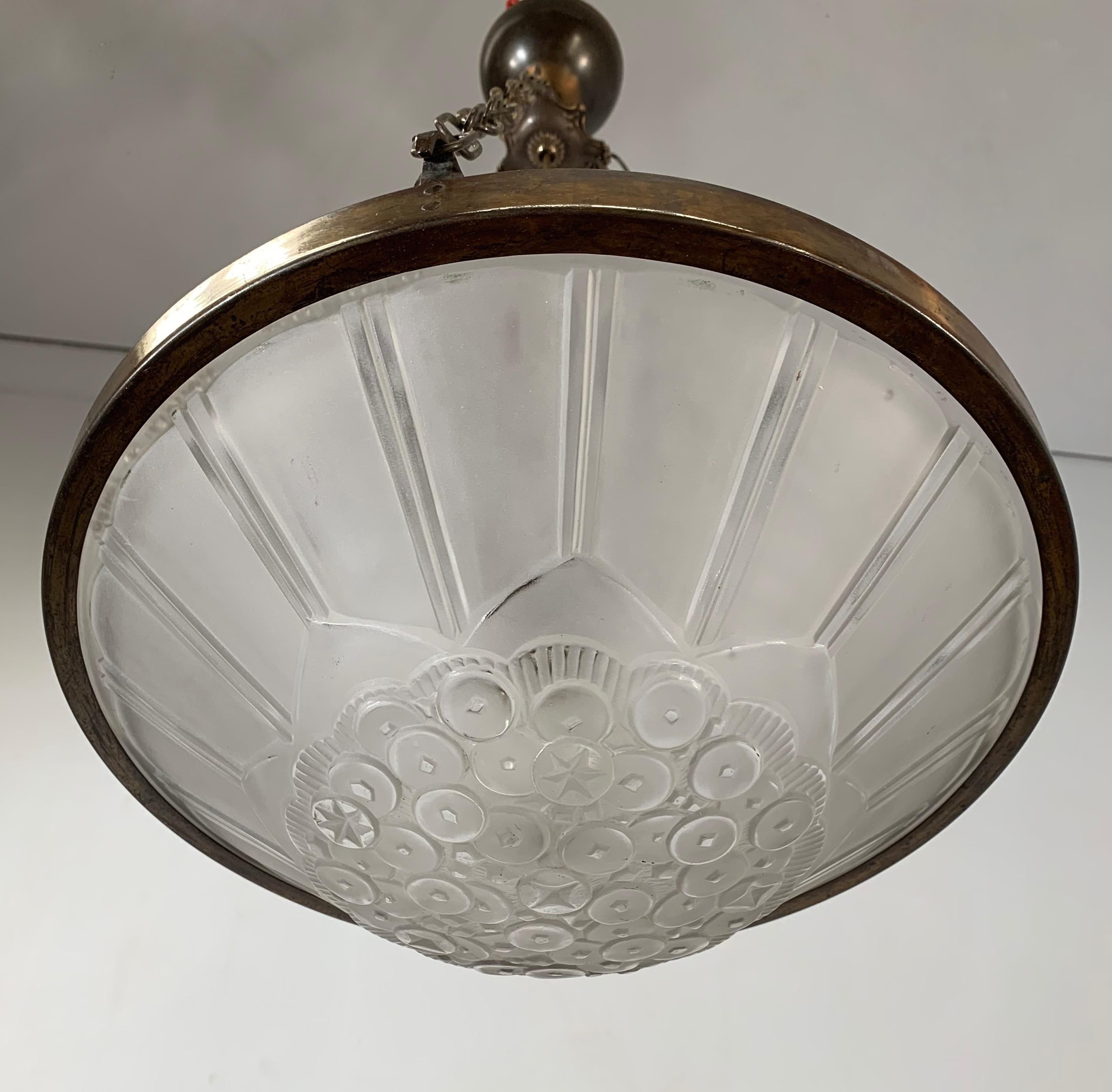 A bargain for the collectors of top quality Parisian Art Deco pendants.

This early 20th century, practical size chandelier is by one of France's finest when it comes to Art Deco light fixtures. For the rich and famous, Parisian makers Genet &