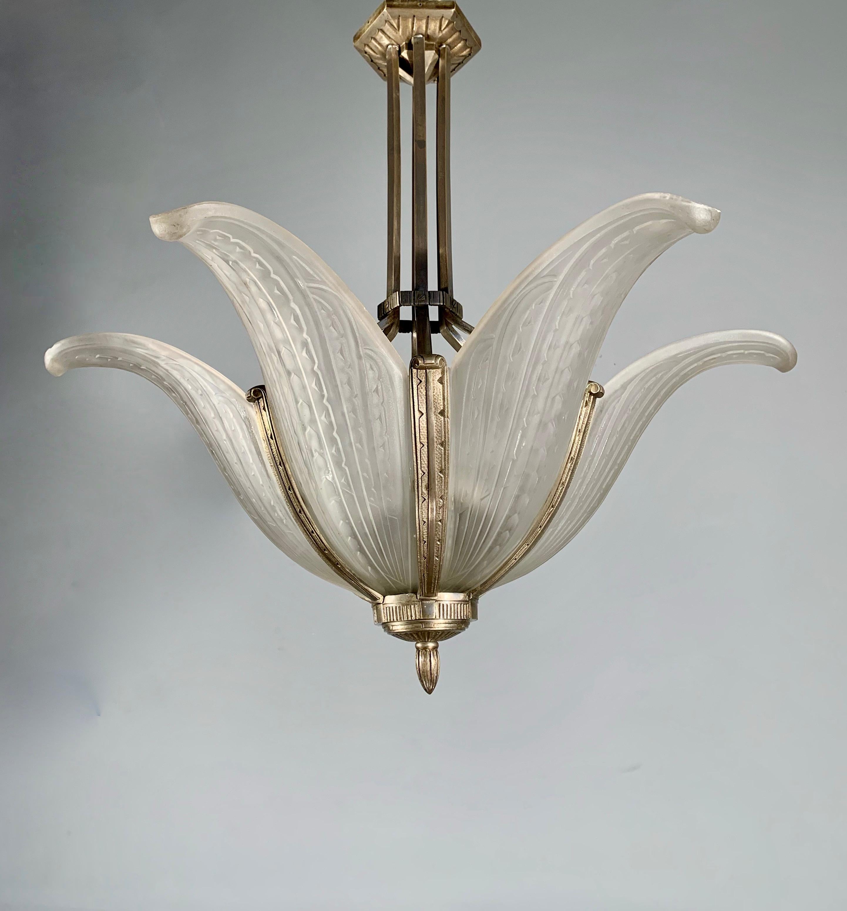 Another bargain for the collectors of top quality Parisian Art Deco pendants.

This stunning, Art Deco palm tree design, bronze and glass chandelier is by one of France's finest when it comes to Art Deco light fixtures. For the rich and famous,