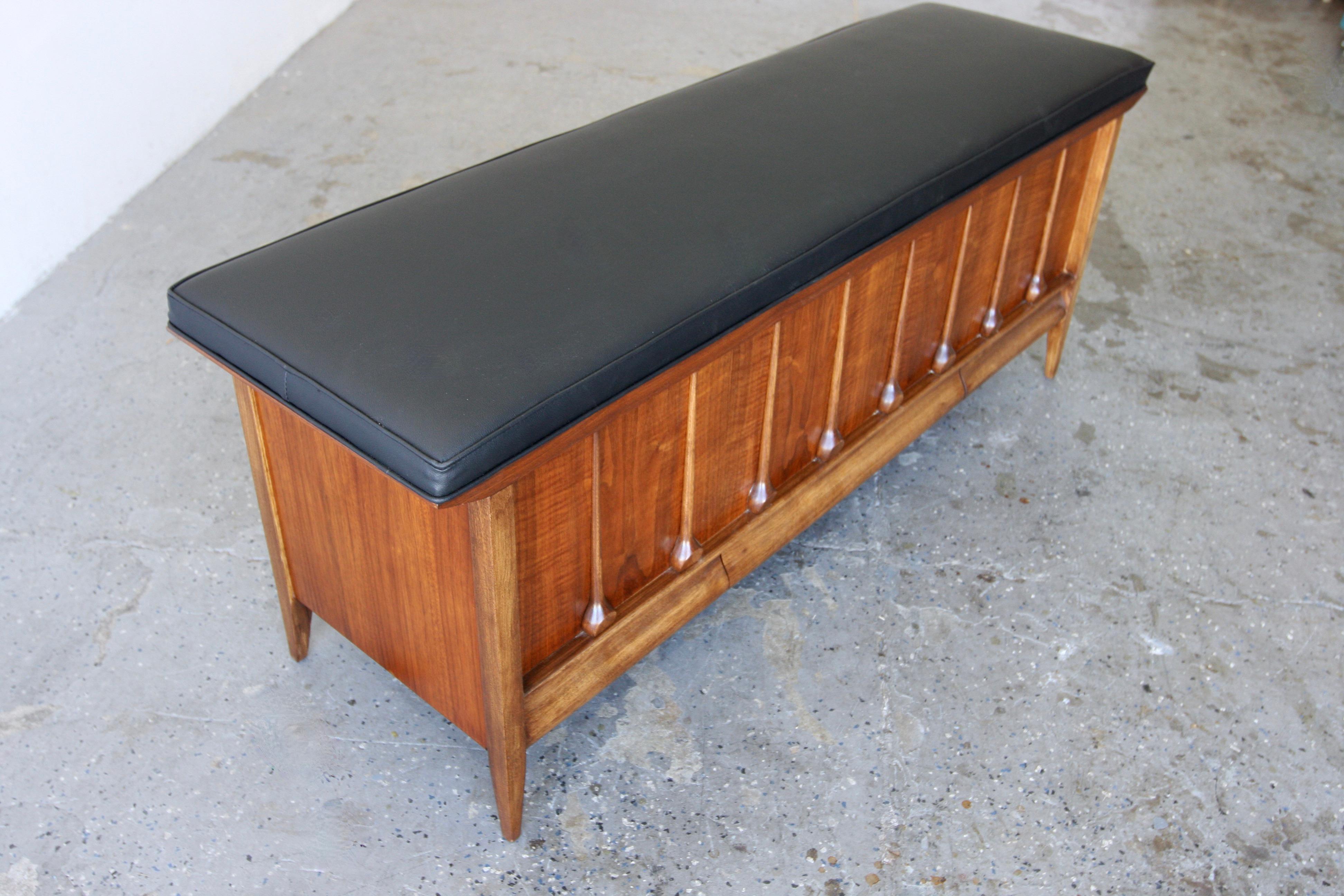 Offered is a  Beautiful and unique Mid-Century Modern cedar blanket chest and bench by Lane Furniture. It is made of cedar with freshly reupholstered with new cushioning and vegan leather. This versatile piece features a Sculptured teardrop design