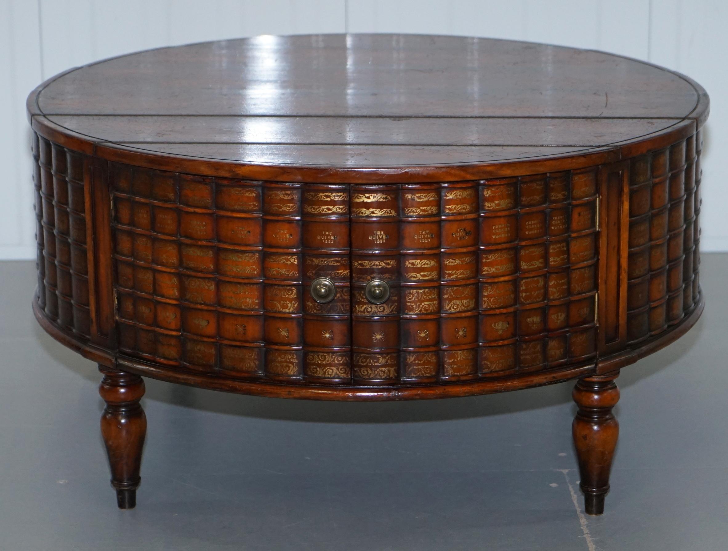 We are delighted to offer for sale this stunning rare Theodore Alexander Regency Drum table Faux Scholars books coffee table with a pair of cupboards 

This table is part of a large suite of six lots of Scholars books side or coffee tables, all